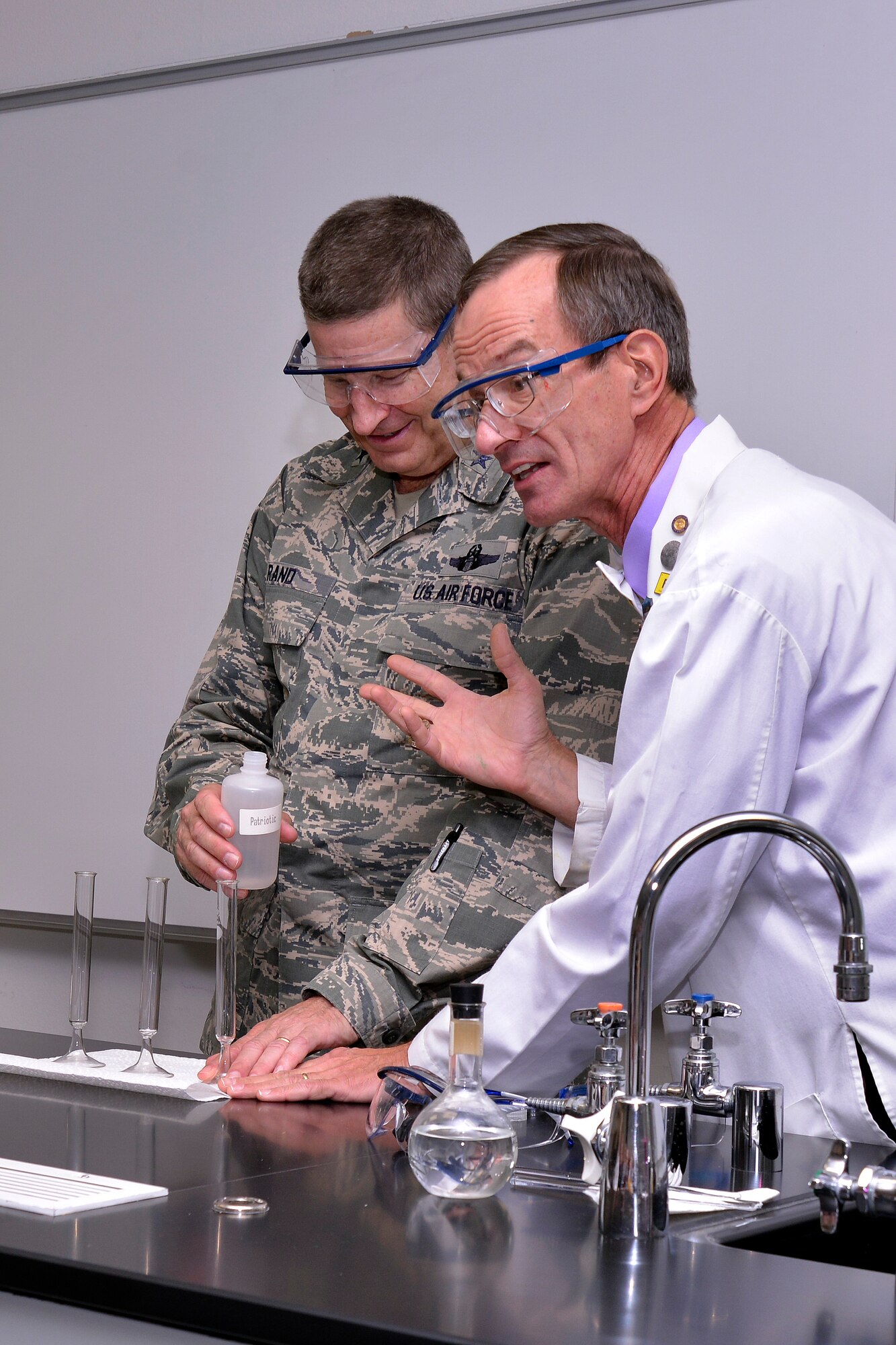 Chemistry Department professor Dr. Ron Furstenau takes Gen. Robin Rand, Air
Education and Training Command commander, through a participate magic show
the professor hosted here Oct. 16, 2014, for Rand and his group of 18 AETC civic
leaders. Rand led a civic leader tour of the Academy Oct. 15 - 16 to
familiarize the civic leaders with the installation's mission of developing
leaders. (U.S. Air Force photo/Jason Gutierrez) 
