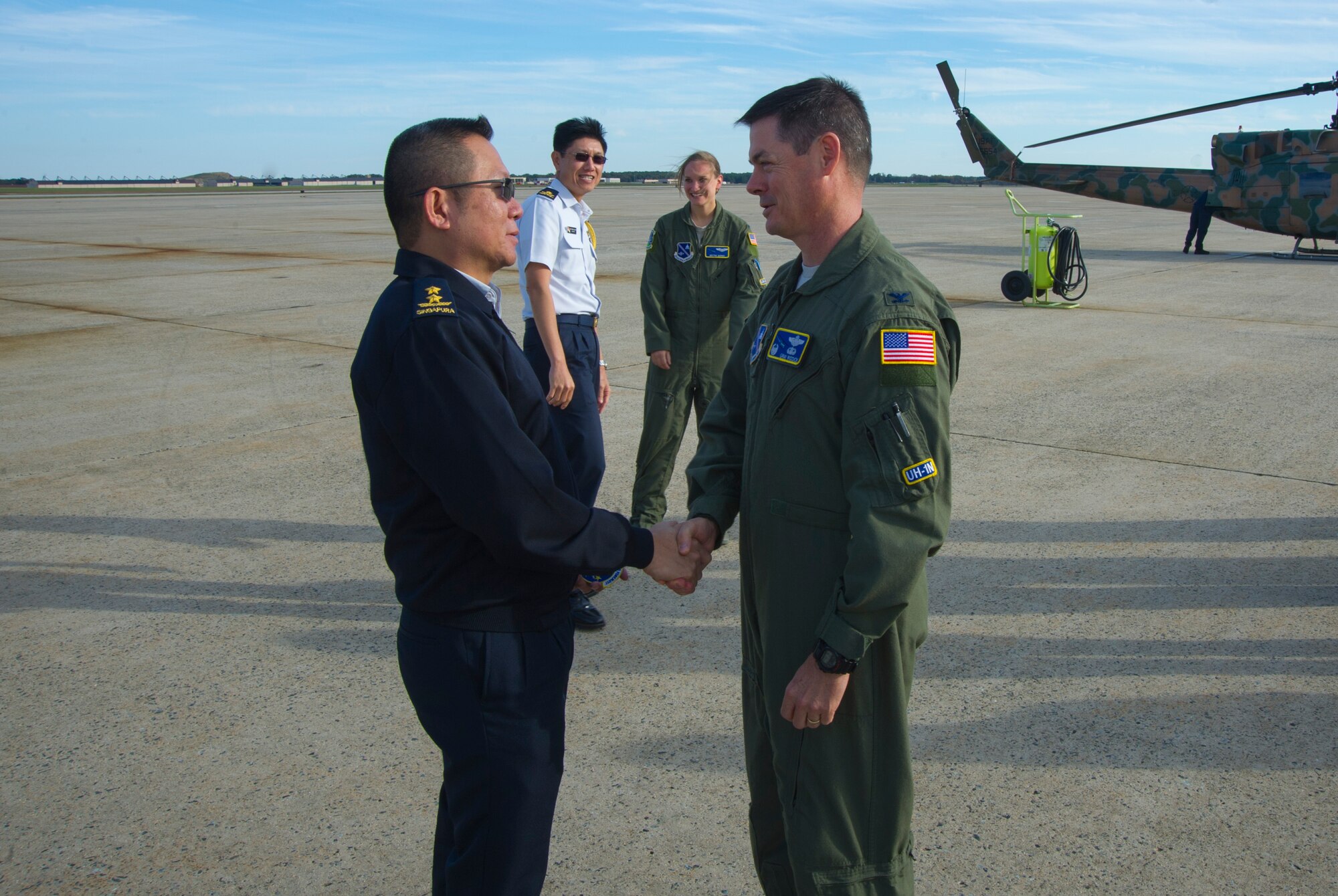 Maj. Gen. Hoo Cher Mou, Chief of the Republic of Singapore Air Force, receives a patch from Col. Larry Riddick, 811th Operations Group commander, on Joint Base Andrews, Md., Oct. 20, 2014. Mou was given an aerial tour of Washington, D.C. from the 811 OG 1st Helicopter Squadron. Mou is visiting U.S. Air Force key programs and receiving briefings from Air Force leaders as a mean to strengthen the coalition relationship. (U.S. Air Force photo/Airman 1st Class Ryan J. Sonnier)