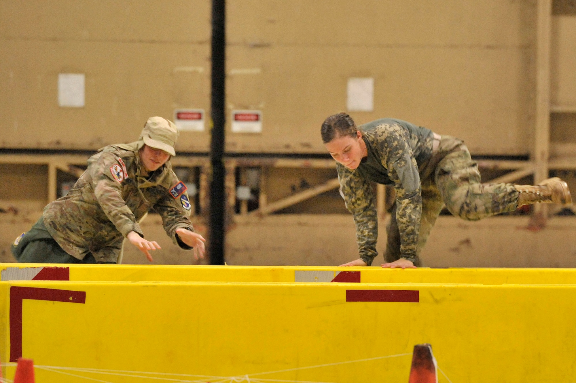 U.S. Air Force Staff Sgt. Scott Tucek, U.S. Air Forces Central intelligence directorate NCO in charge of air defense command and control, competes against Airman 1st Class Brittany Windju, AFCENT intelligence directorate air defense analyst, in the gauntlet preceding the grog bowl during the AFCENT intelligence directorate’s combat dining-in at Shaw Air Force Base, S.C., Oct. 10, 2014. The gauntlet was a series of obstacles Airmen had to get through before making it to the grog bowl. (U.S. Air Force photo by Airman 1st Class Jonathan Bass/Released)