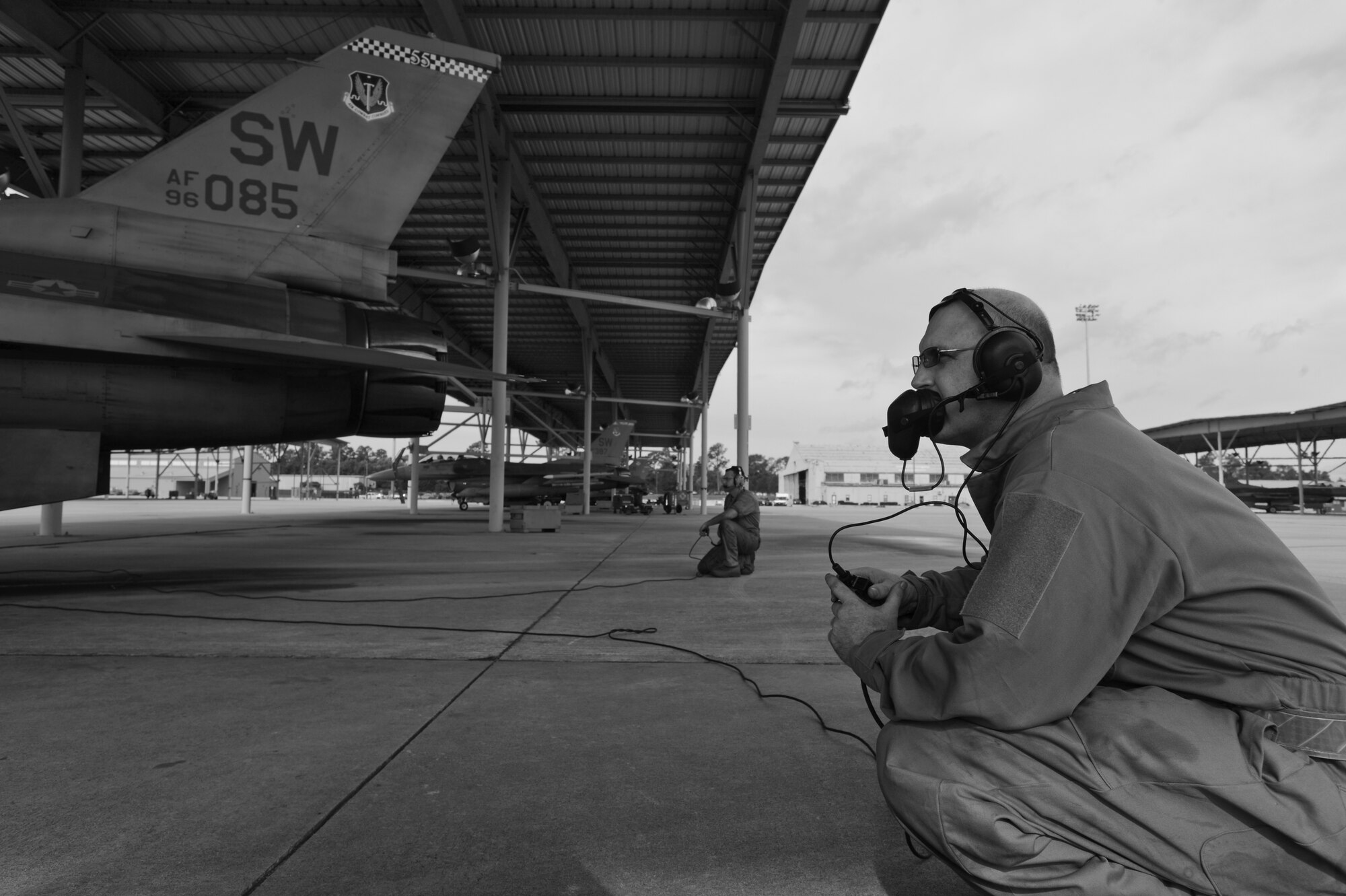 U.S. Air Force Chief Master Sgt. Charles Mills, 20th Fighter Wing command chief, listens in on a conversation between a pilot and crew chief at Shaw Air Force Base, S.C., Oct. 14, 2014. Mills assisted with the crew chiefs’ preflight inspection and marshaled the aircraft during his day shadowing a tactical aircraft maintainer. (U.S. Air Force photo by Senior Airman Tabatha Zarrella/Released)
