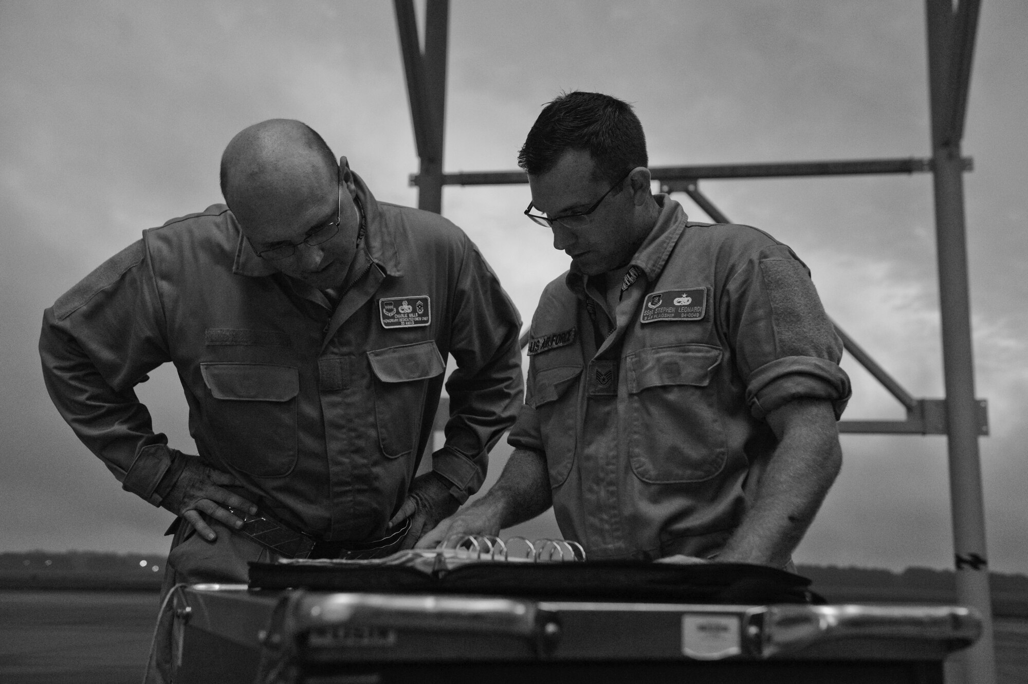 U.S. Air Force Chief Master Sgt. Charles Mills, 20th Fighter Wing command chief, looks at a preflight inspection list with Staff Sgt. Stephen Leonardi, 20th Aircraft Maintenance Squadron tactical aircraft maintainer, at Shaw Air Force Base, S.C., Oct. 14, 2014. Mills shadowed Leonardi for a 12-hour shift, learning many tasks of a crew chief. (U.S. Air Force photo by Senior Airman Tabatha Zarrella/Released)