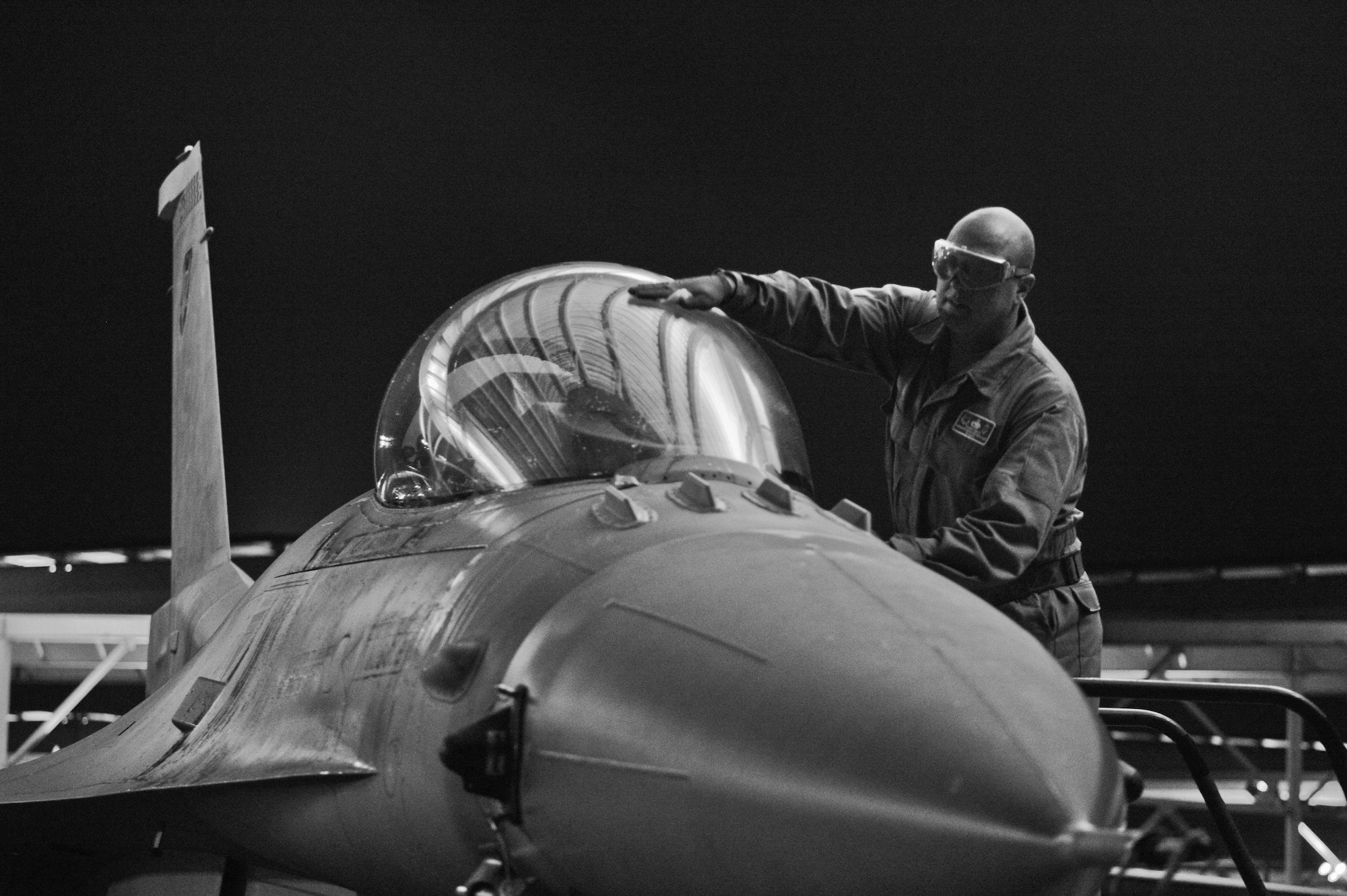 U.S. Air Force Chief Master Sgt. Charles Mills, 20th Fighter Wing command chief, washes the canopy of an F-16CM Fighting Falcon at Shaw Air Force Base, S.C., Oct. 14, 2014. Mills spent a 12-hour shift shadowing a crew chief to get a better understanding of the crew chiefs’ job and how they get the jets in the air. (U.S. Air Force photo by Senior Airman Tabatha Zarrella/Released)