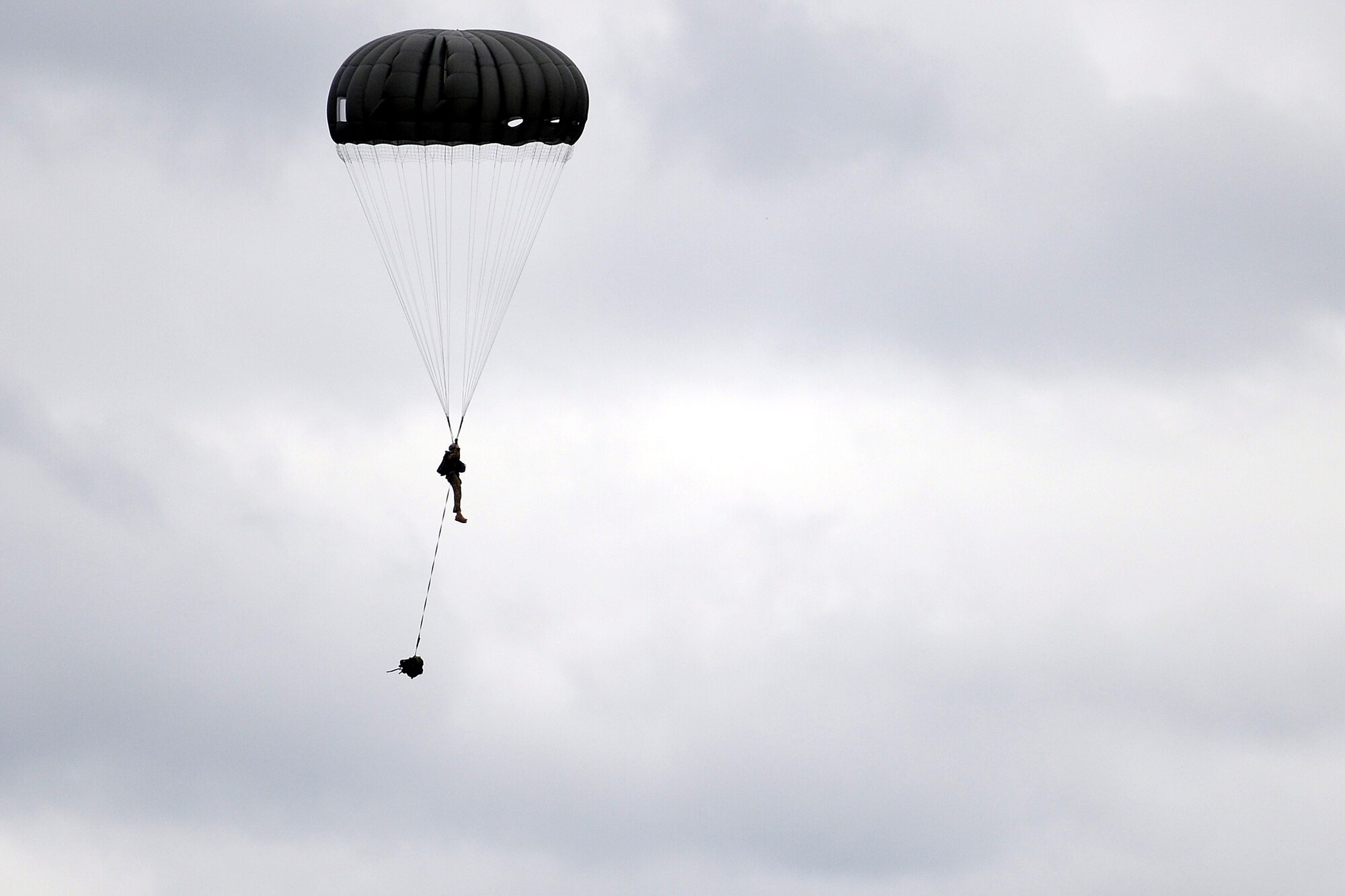 An Airman from the 22nd Special Tactics Squadron parachutes toward the ground after jumping from a C-17 Globemaster III October 21, 2014, during a training exercise at Joint Base Lewis-McChord, Wash. The Special Tactics Airmen conducted static line jumps from 1,000 feet and high altitude low opening jumps from 5,500 feet. (U.S. Air Force photo/A1C Keoni Chavarria)