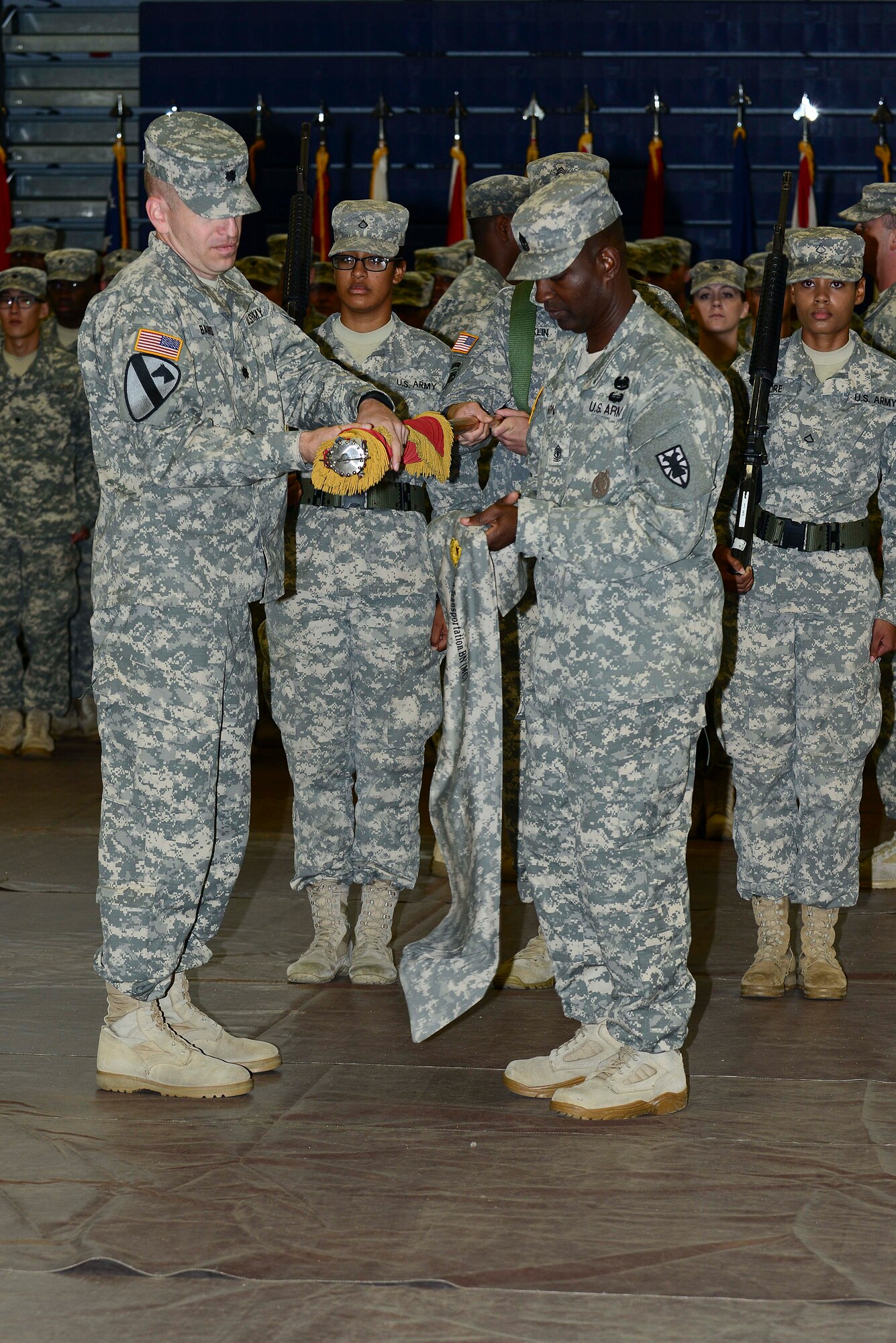 U.S. Army Lt. Col. Kevin Baird, 53rd Transportation Battalion (Movement Control), commander, and 1st Sgt. Calvin Liggons, 3rd Trans. Btn. (MC) first sergeant, begin to perform a casing of the colors during a deployment ceremony at Fort Eustis, Va., Oct. 22, 2014. The battalion deployed to West Africa in support of Operation United Assistance. (U.S. Air Force photo by Airman 1st Class Kimberly Nagle/Released)