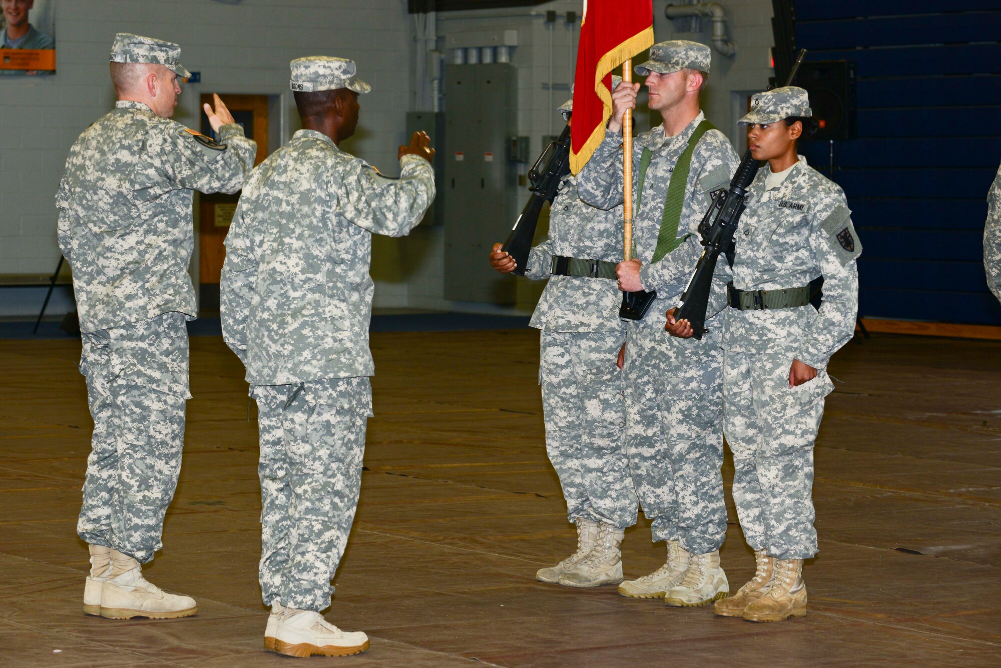 U.S. Army Lt. Col. Kevin Baird, 53rd Transportation Battalion (Movement Control), commander, and 1st Sgt. Calvin Liggons, 3rd Trans. Btn. (MC) first sergeant, begin to perform a casing of the colors during a deployment ceremony at Fort Eustis, Va., Oct. 22, 2014. The battalion deployed to West Africa in support of Operation United Assistance. (U.S. Air Force photo by Airman 1st Class Kimberly Nagle/Released)