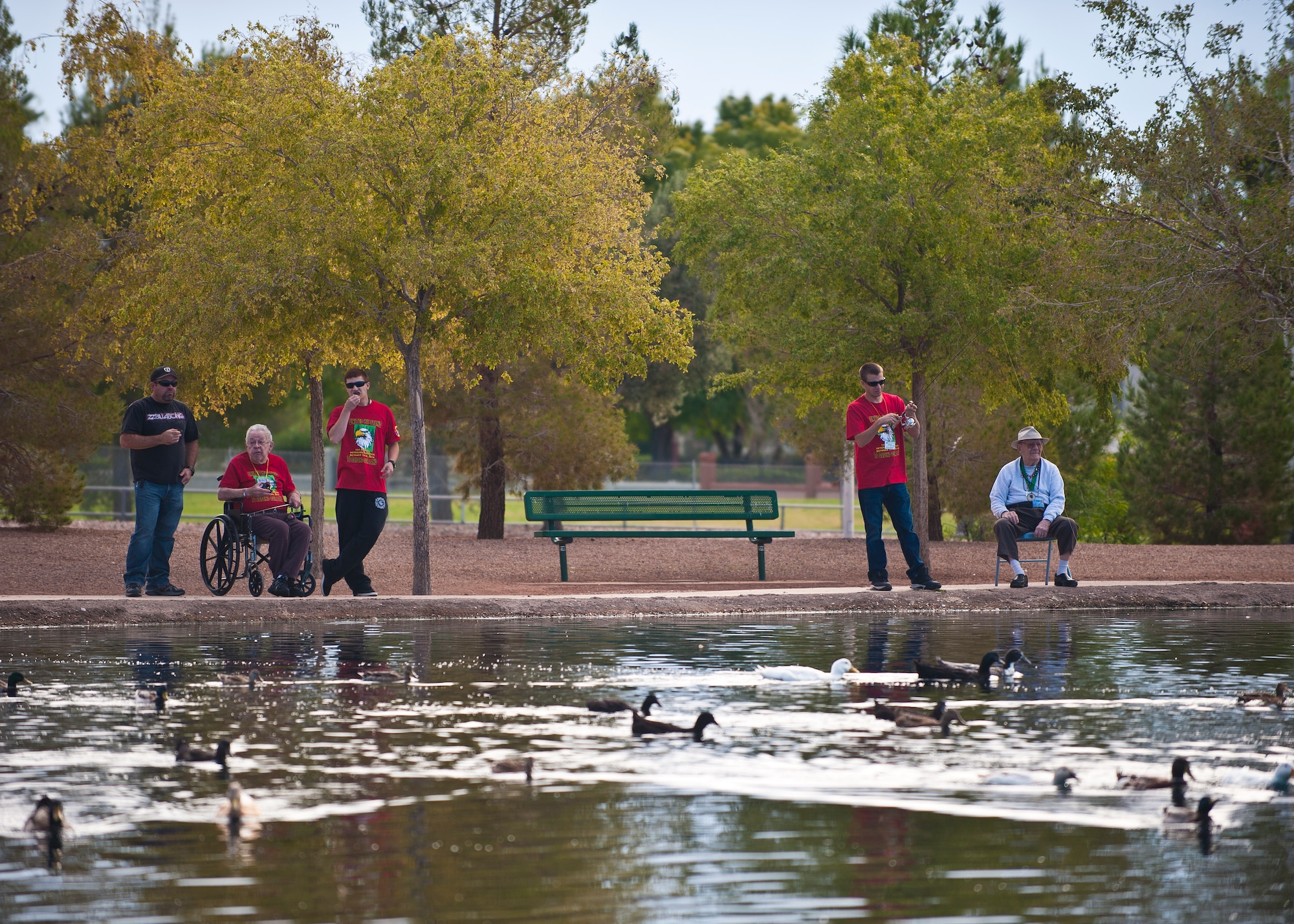 Residents of the Nevada State Veterans Home are assisted by service members from Nellis and Creech Air Force Bases during the home’s annual fishing tournament at the Veterans’ Memorial Park in Boulder City, Nev., Oct. 17, 2014. Approximately 20 volunteers interacted with the residents, shared stories of service, and assisted them with catching and releasing fish. The fishing tournament was part of the Nevada State Veterans Home’s Veterans Olympics. (U.S. Air Force photo by Staff Sgt. Siuta B. Ika)