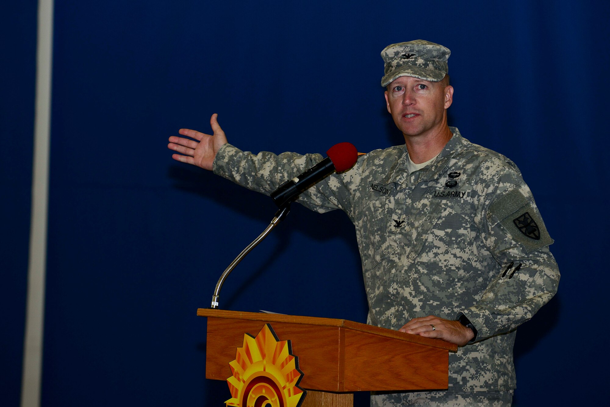 U.S. Army Col. Randal Nelson, 7th Transportation Brigade (Expeditionary) commander, speaks to the crowd during a deployment ceremony at Fort Eustis, Va., Oct. 22, 2014. While in West Africa, personnel are responsible for moving medical and construction equipment to support the building of an Ebola treatment facility. Soldiers are not expected to have any contact with Ebola patients, but they received training on personal protective equipment as a precautionary measure. (U.S. Air Force photo by Airman 1st Class Kimberly Nagle/Released)