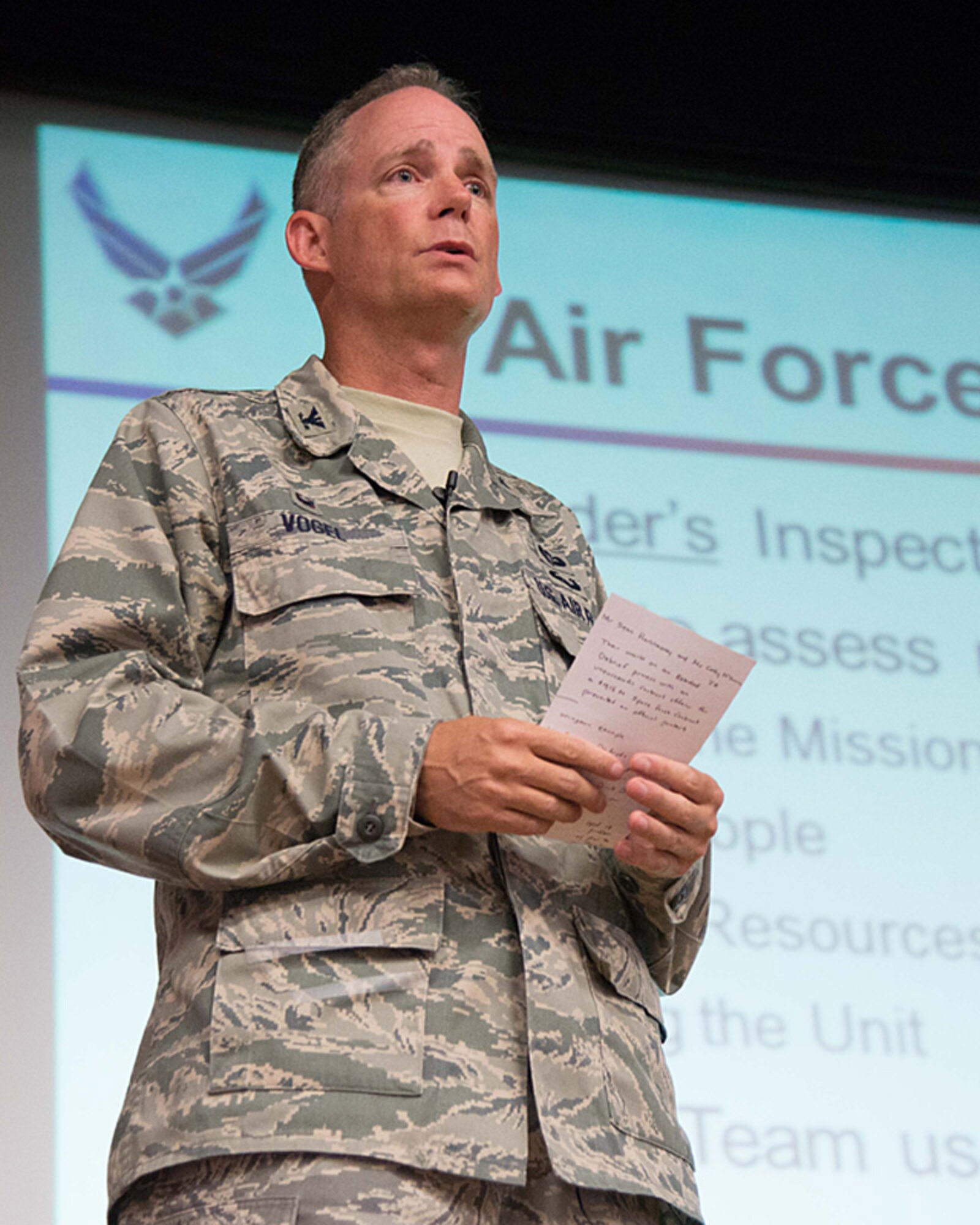 Col. Michael A. Vogel, 66th Air Base Group commander, addresses the workforce on the Commander's Inspection Program during an ABG commander's call in the base theater Oct. 22. The commander and other subject matter experts from ABG agencies spoke about the Combined Federal Campaign, fall safety, the Enlisted Evaluation System and more. (U.S. Air Force photo by Mark Herlihy)
