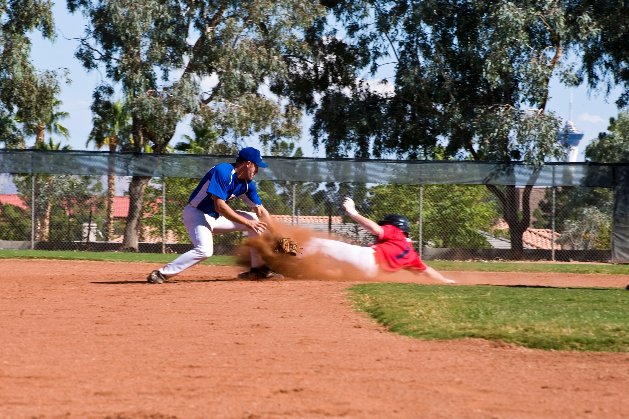 Zachary Crutchman, Las Vegas Blues baseball team second baseman, attempts a tag on a member of the Las Vegas Angels during the Southern Nevada Adult League championship game at Rainbow Family Park in Las Vegas, Nev., Oct. 19, 2014. The Angels won the game 10-0 to take the championship. (U.S. Air Force photo by Airman 1st Class Mikaley Towle)
