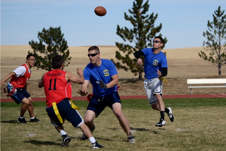 Josh Print, 1st Space Operations Squadron quarterback, attempts a pass during the second half of the Schriever Flag Football Championship game Oct. 17, 2014 at Schriever Air Force Base, Colo.  The 3rd Space Operations Squadron beat 1 SOPS 31-25 to claim the championship. (U.S. Air Force photo/Christopher DeWitt)