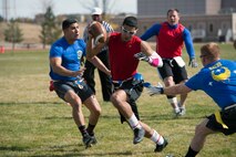 Shane Gardner, 3rd Space Operations Squadron quarterback, scrambles during the first half of the Schriever Flag Football Championship game Oct. 17, 2014 at Schriever Air Force Base, Colo. Gardner and 3 SOPS handed the 1st Space Operations Squadron its first loss of the season while claiming the championship with a 31-25 victory. (U.S. Air Force photo/Christopher DeWitt)