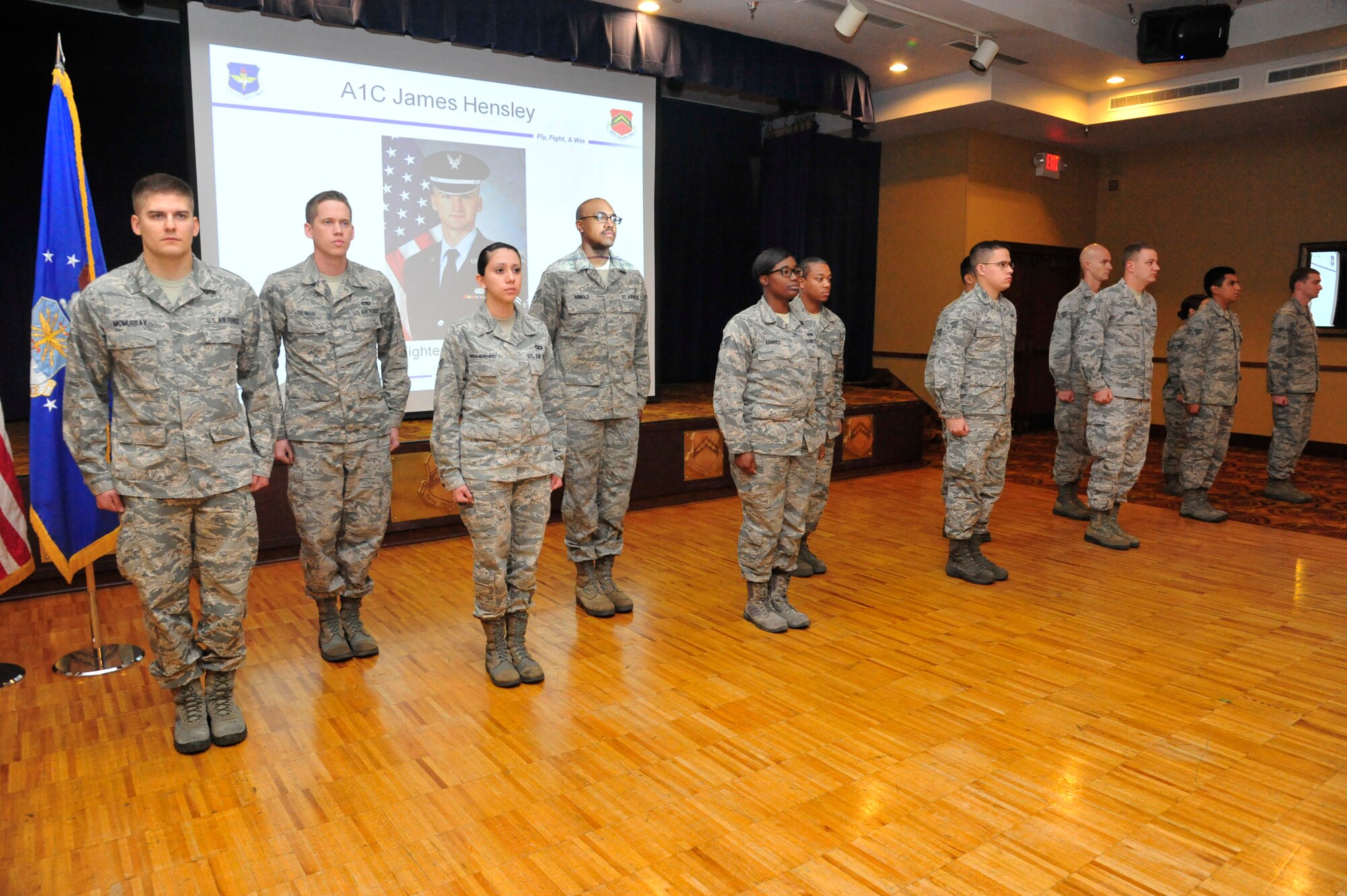 Luke Air Force Base Honor Guardsmen stand at attention as they are called to the front of the room Oct. 8 in Club Five Six. The Airmen were recognized and awarded the Air Force Achievement Medal for their one-year commitment to the Luke Honor Guard. (U.S. Air Force photo/Senior Airman Grace Lee)