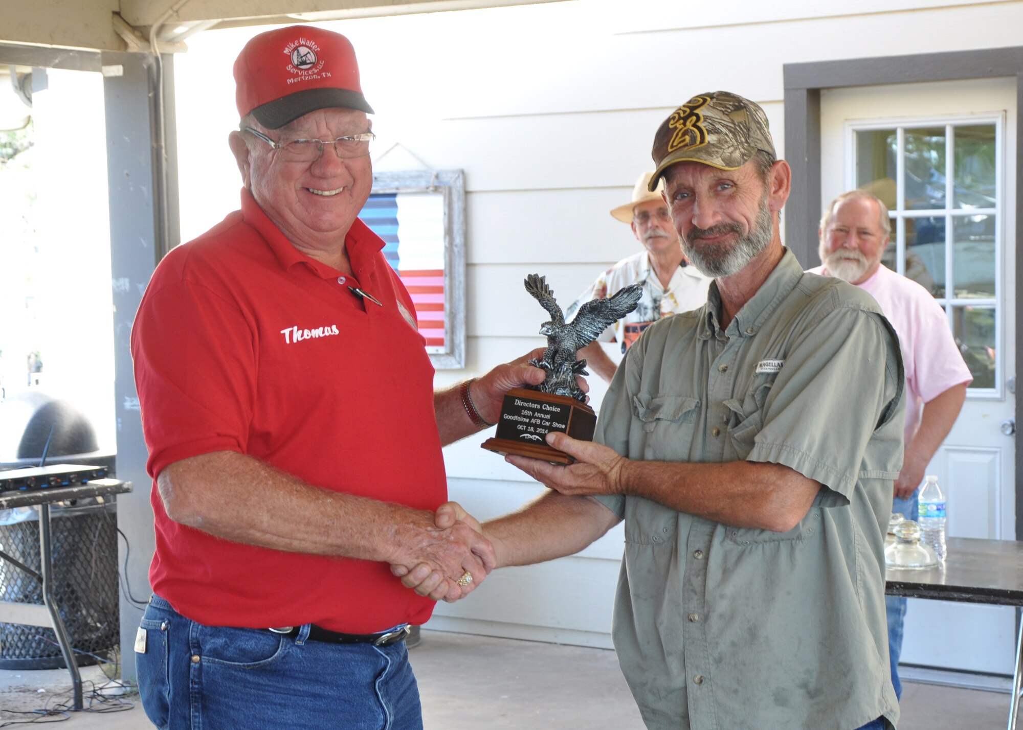 GOODFELLOW AIR FOCE BASE, Texas – Harry F. Gilbert, right, Goodfellow Air Force Base Recreation Camp director, awards the Director’s Choice trophy to Thomas Rose, car show competitor, during the 16th Annual Goodfellow Recreation Camp Car, Boat and Motorcycle Show Oct. 18. Rose received the trophy for his 1940 Ford Coupe. (U.S. Air Force photo/ Senior Airman Joshua Edwards)