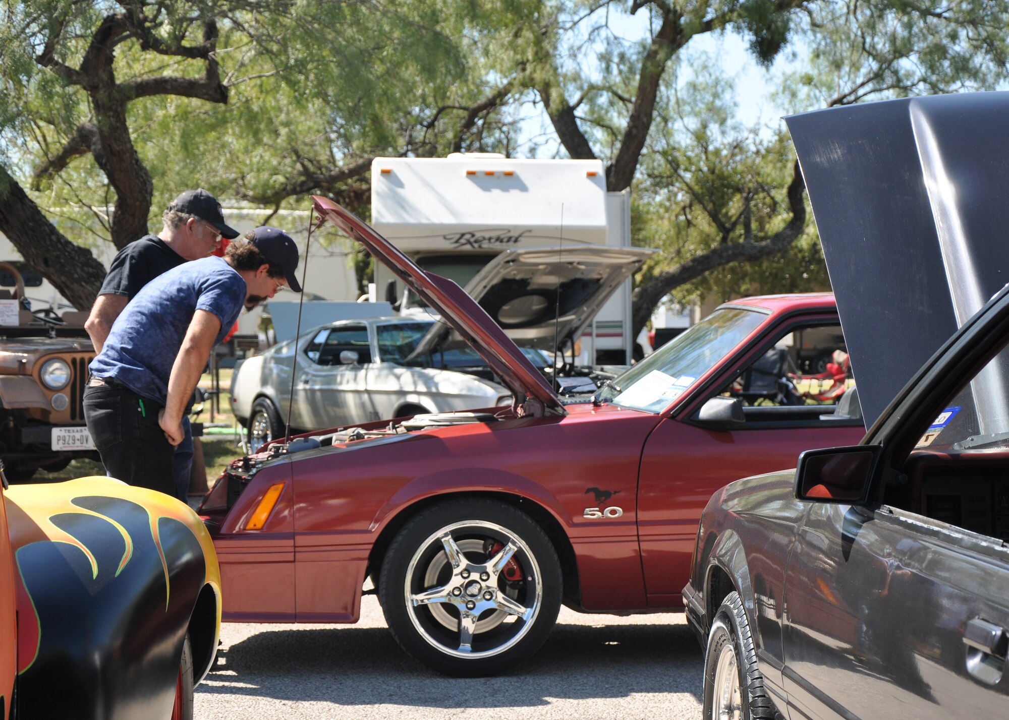 GOODFELLOW AIR FOCE BASE, Texas – Calvin L. Steward Sr. and Jr., car show competitors, look at a car competing in the same category as their own during the 16th Annual Goodfellow Recreation Camp Car, Boat and Motorcycle Show Oct. 18. The Stewards, other competitors and the public voted on cars in 16 different categories to determine the winners. (U.S. Air Force photo/ Senior Airman Joshua Edwards)