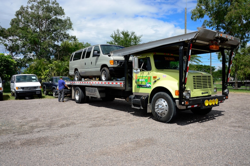 Members of Joint Task Force-Bravo’s Civil and Military Operations Office help load vehicles donated through the Defense Reutilization and Marketing Office onto flat bed trucks on Soto Cano Air Base, Honduras, Oct. 14, 2014. DRMO, the U.S. State Department and the U.S. Agency for International Development worked together to transfer over $100,000 worth of furniture and vehicles to USAID project Youth Alliance Honduras.  DRMO offices receive and screen all property turned in by base agencies for reutilization and reuse. If items cannot be reused within the Department of Defense, it is considered for transfer or donation to other federal or state agencies, or other qualified organizations.  (U.S. Air Force photo /Tech. Sgt. Heather Redman)