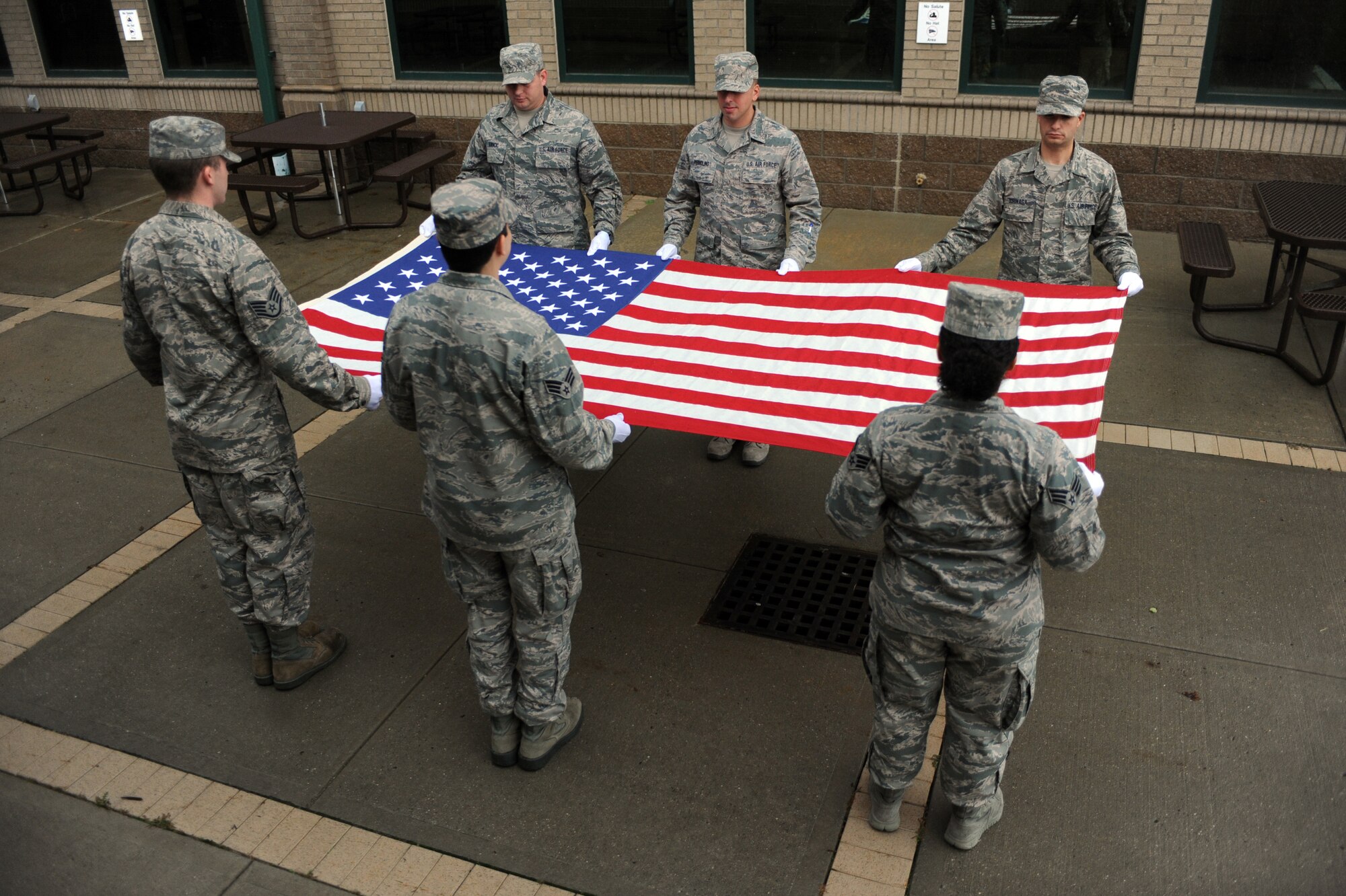 Members of the New York Air National Guard's 106th Rescue Wing Base Honor Guard rehearse a flag folding and presentation ceremony at Gabreski Air National Guard Base Oct. 16, 2014. The Honor Guard Airmen performed more than 619 ceremonies in 2013. This was more than any other Air National Guard Honor Guard in the Country. (U.S. Air National Guard Photo by Senior Airman Christopher S. Muncy/Released)