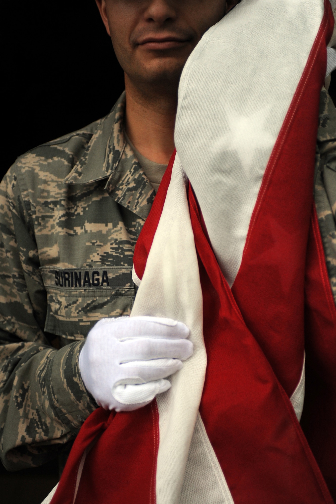 A member of the New York Air National Guard's 106th Rescue Wing Base Honor Guard folds the American flag while rehearsing detail duties at Gabreski Air National Guard Base on Oct.16, 2014. The 106th Rescue Wing Honor Guard performed 619 ceremonial details in 2013. This was more than any other team in the Air National Guard. (U.S. Air National Guard photo by Senior Airman Christopher S. Muncy/Released)