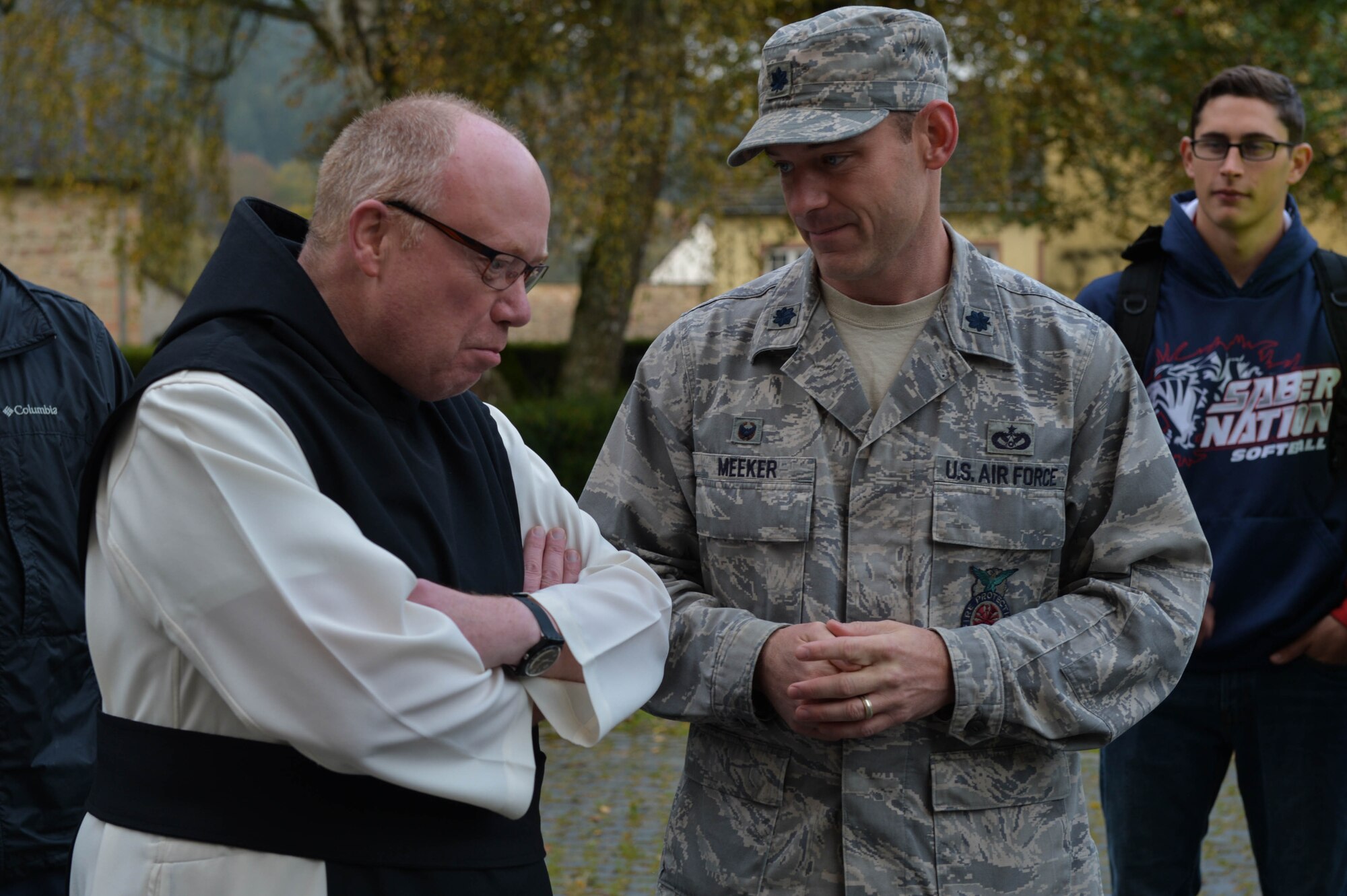 U.S. Air Force Lt. Col. Christopher Meeker, 52nd Civil Engineer Squadron commander and native of Manito, Ill.,  talks with Father Ignatius Fritsch in the cloister of Himmerod Abbeyin Grosslittgen, Germany,Oct. 21, 2014. Airmen from the 52nd CES volunteered to help pick apples for the monks and received a free lunch for helping out. (U.S. Air Force photo by Airman 1st Class Kyle Gese/Released)