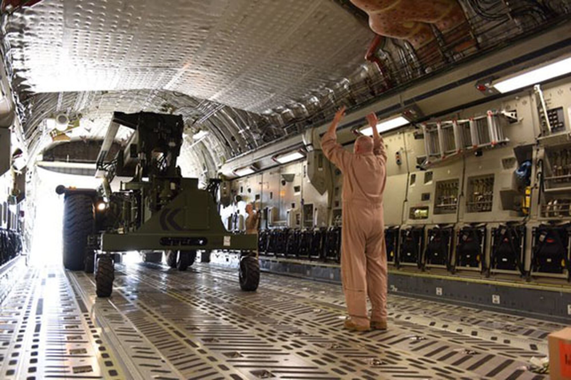 MIDDLETOWN, Pa.  – Senior Master Sgt. Kevin Steyer, 89th Airlift Squadron loadmaster, directs the driver of a rough terrain container handler onto a 445th Airlift Wing C-17 Globemaster III, while at the 193rd Special Operations Wing, Middletown, Pennsylvania, Oct. 16, 2014. The 445th AW transported the RTCH to Africa in support of the Ebola crisis. (U.S. Air National Guard photo by Tech. Sgt. Culeen Shaffer/Released)