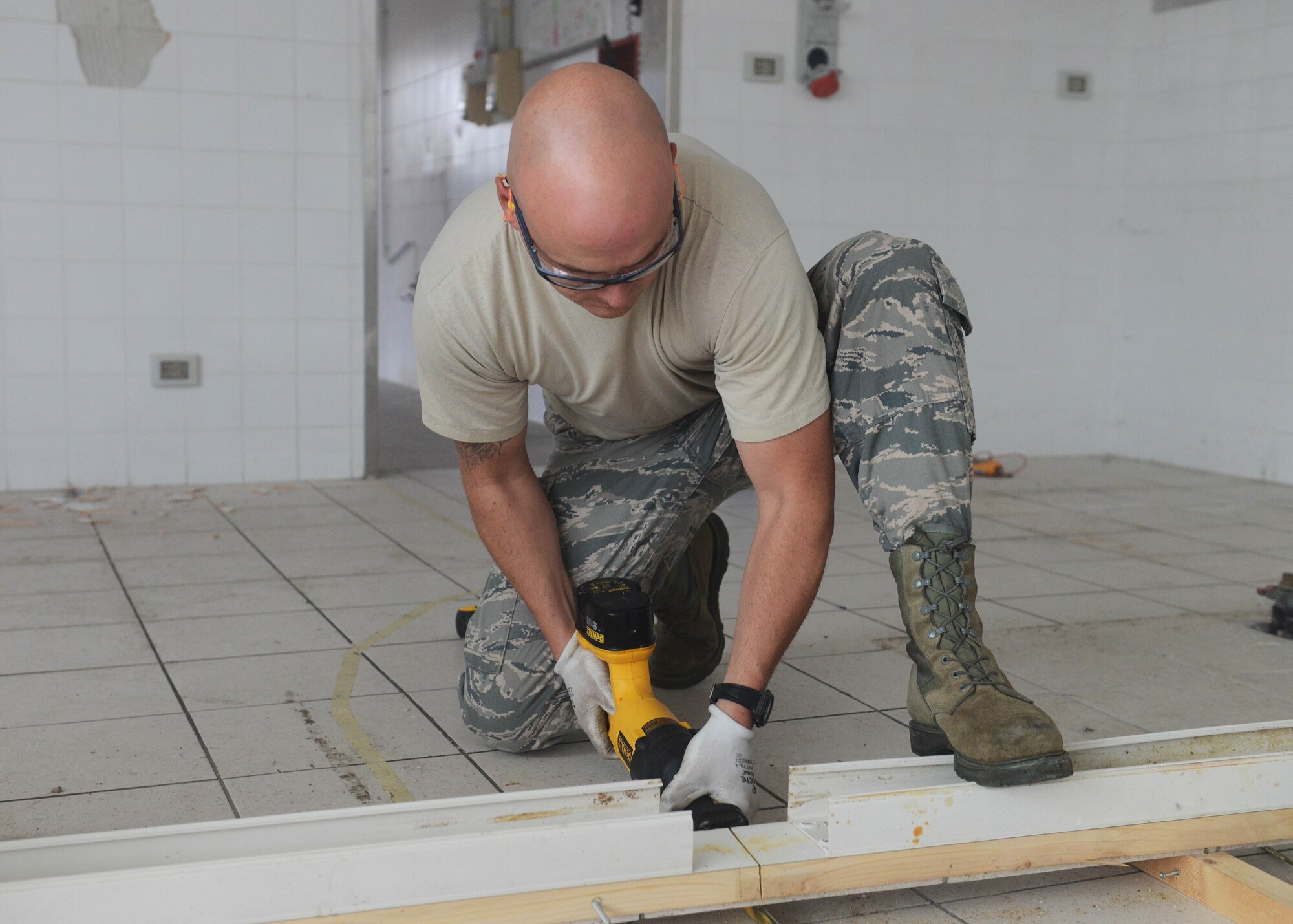 Tech Sgt. Brandyn Walter, 31st Civil Engineer Squadron structures craftsman, handsaws a piece of wood, Oct. 20, 2014, at Aviano Air Base, Italy. The most recent project is the Troop Training Project, which was launched to establish a new urinalysis facility. (U.S. Air Force photo/Airman 1st Class Deana Heitzman)