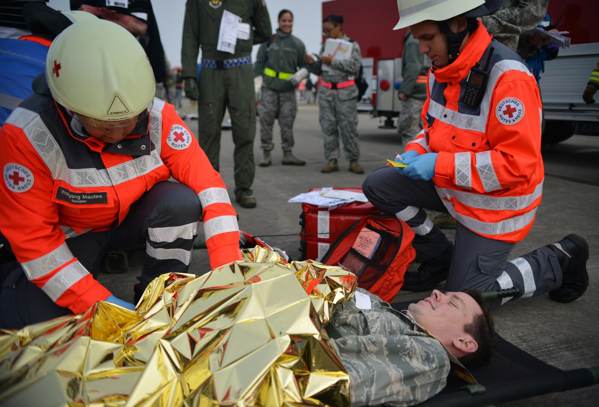 Host Nation medical technicians assist in efforts to care for injured passengers of a simulated aircraft crash during a Major Accident Response Exercise on Ramstein Air Base, Germany, Oct. 18, 2014. Members of the U.S. Air Force and Host Nation agencies partnered in conducting a response and recovery exercise in preparation for possible real-world incidents. (U.S. Air Force photo/Senior Airman Hailey Haux)