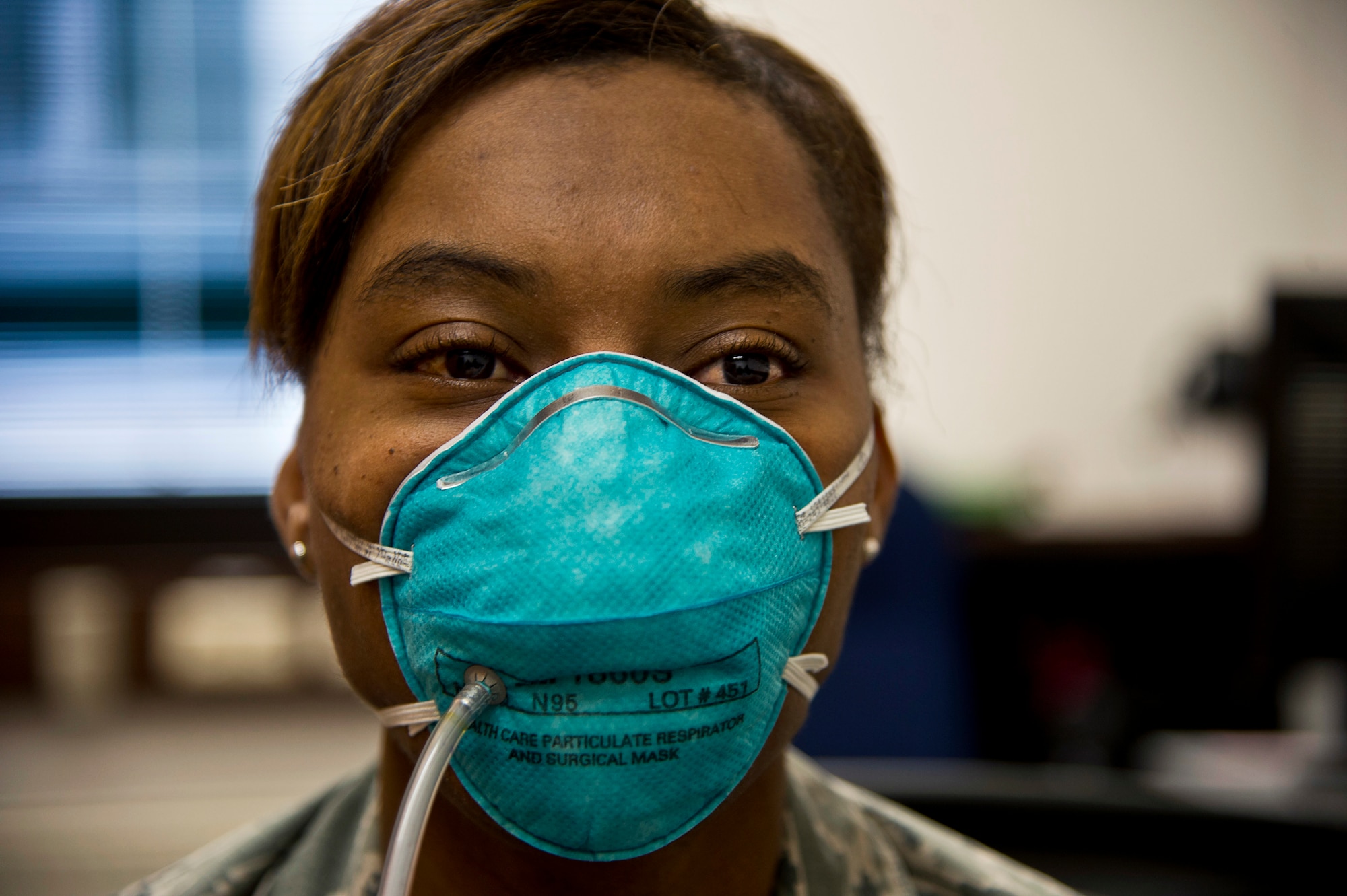 Tech. Sgt. Saquadrea Crosby, 86th Aerospace Medicine Squadron public health NCOIC, gets fitted for an N95 respirator by 86th Bioenvironmental Engineering flight at Ramstein Air Base, Germany, Oct. 17, 2014. The N95 respirator is a device that is used to help prevent the spread of germs (viruses and bacteria) from one person to another. As members of the 86th Airlift Wing continue to support missions for Operation United Assistance, Airmen who are expected to interact with returnees from Ebola infected areas will be fitted for the N95 respirators. (U.S. Air Force photo by Staff Sgt. Sara Keller)