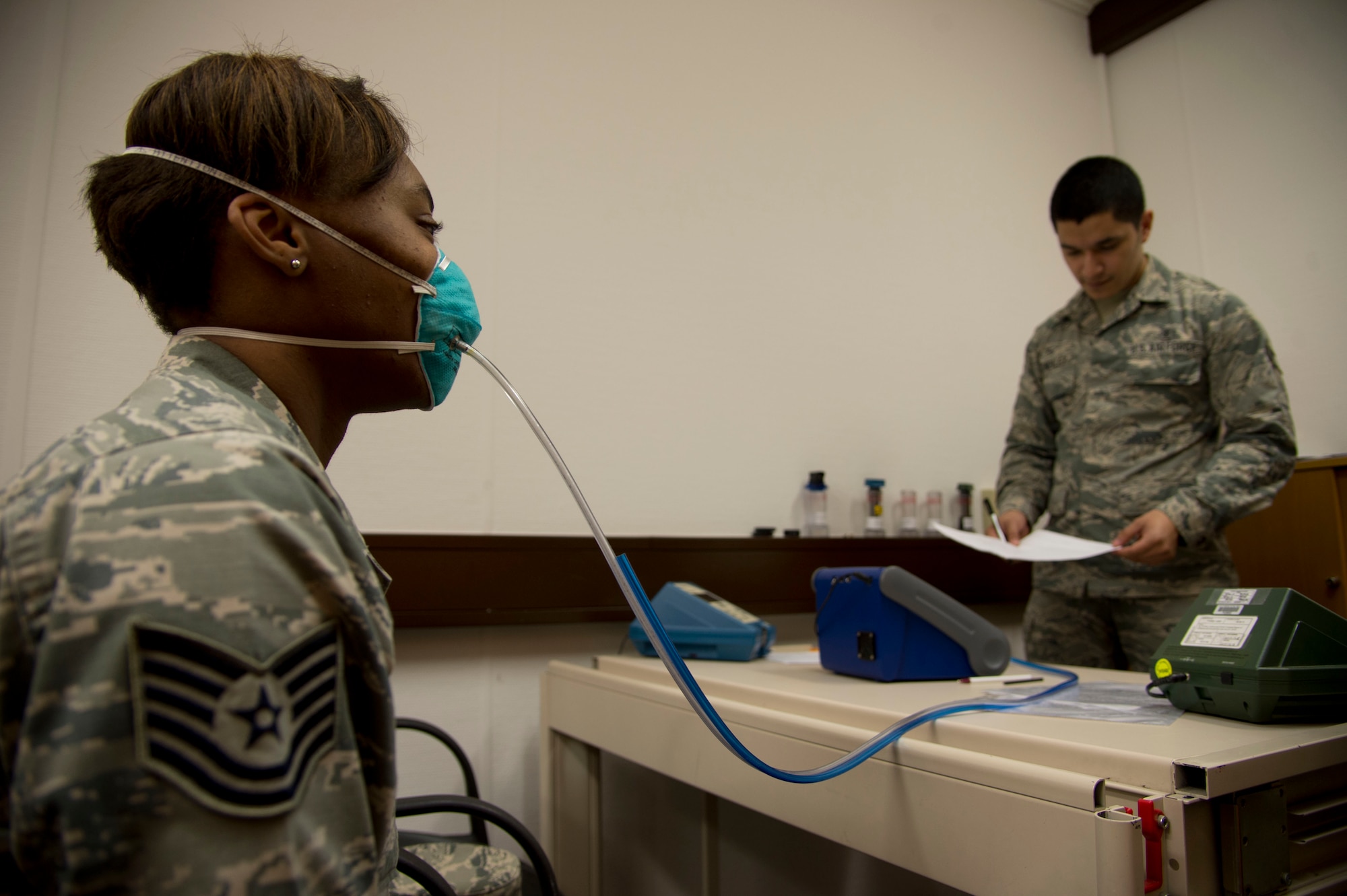 Tech. Sgt. Saquadrea Crosby, 86th Aerospace Medicine Squadron public health NCOIC, gets fitted for an N95 respirator by Airman 1st Class Aaron Gonsalez, 86th Bioenvironmental Engineering technician, at Ramstein Air Base, Germany, Oct. 17, 2014. The N95 respirator is a device that is used to help prevent the spread of germs (viruses and bacteria) from one person to another. As members of the 86th Airlift Wing continue to support missions for Operation United Assistance, Airmen who are expected to interact with returnees from Ebola infected areas will be fitted for the N95 respirators. (U.S. Air Force photo by Staff Sgt. Sara Keller)