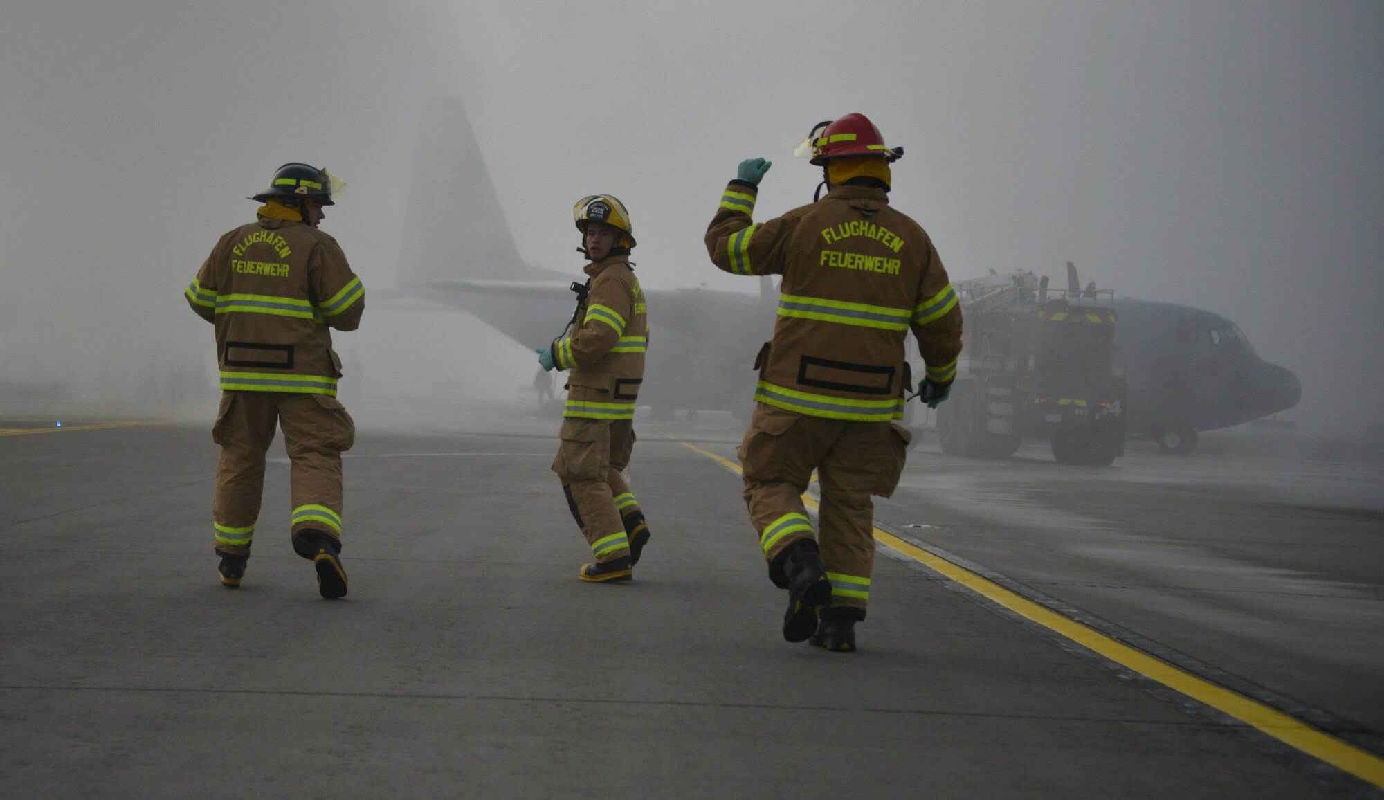 A group of firefighters runs toward the scene of a simulated aircraft crash during a Major Accident Response Exercise on Ramstein Air Base, Germany, Oct. 18, 2014. Members of the U.S. Air Force and Host Nation agencies partnered in conducting a response and recovery exercise in preparation for possible real-world incidents. (U.S. Air Force photo/Senior Airman Hailey Haux)