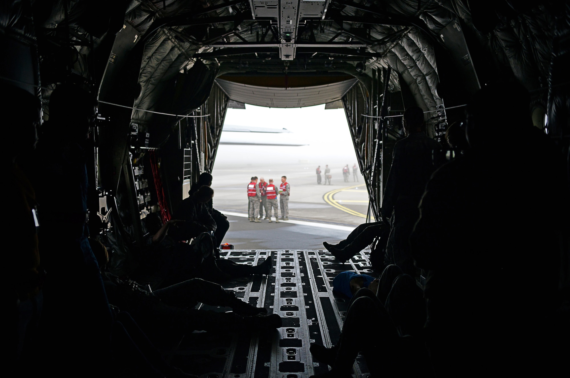A group of Wing Inspection Team members gather outside a C-130J Super Hercules to discuss the Major Accident Response Exercise before it kicks off on Ramstein Air Base, Germany, Oct. 18, 2014. Members of the U.S. Air Force and Host Nation agencies partnered in conducting a response and recovery exercise in preparation for possible real-world incidents. (U.S. Air Force photo/Senior Airman Hailey Haux)