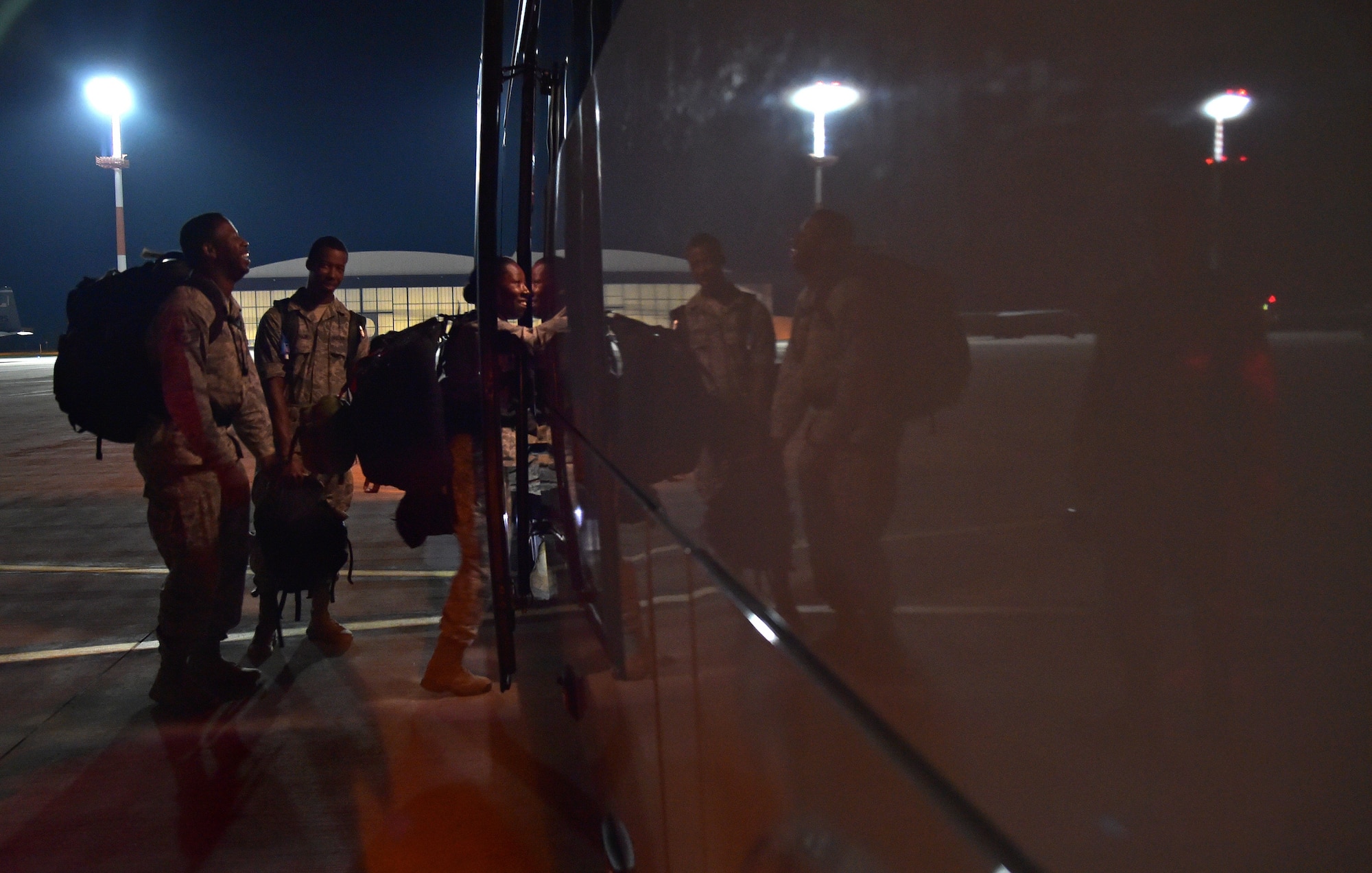 Airmen board a bus on the flightline after arriving at Ramstein Air Base, Germany from West Africa, Oct. 19, 2014. Any personnel traveling into Ramstein from Ebola infected areas will be medically screened upon their arrival and cleared by public health for onward travel to ensure the health and safety of all passengers, aircrew and members of the Kaiserslautern community. (U.S. Air Force photo/Staff Sgt. Sara Keller)