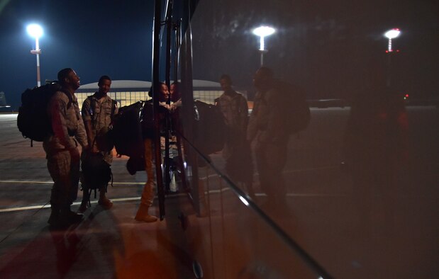 Airmen board a bus on the flightline after arriving at Ramstein Air Base, Germany from West Africa, Oct. 19, 2014. Any personnel traveling into Ramstein from Ebola infected areas will be medically screened upon their arrival and cleared by public health for onward travel to ensure the health and safety of all passengers, aircrew and members of the Kaiserslautern community. (U.S. Air Force photo/Staff Sgt. Sara Keller)