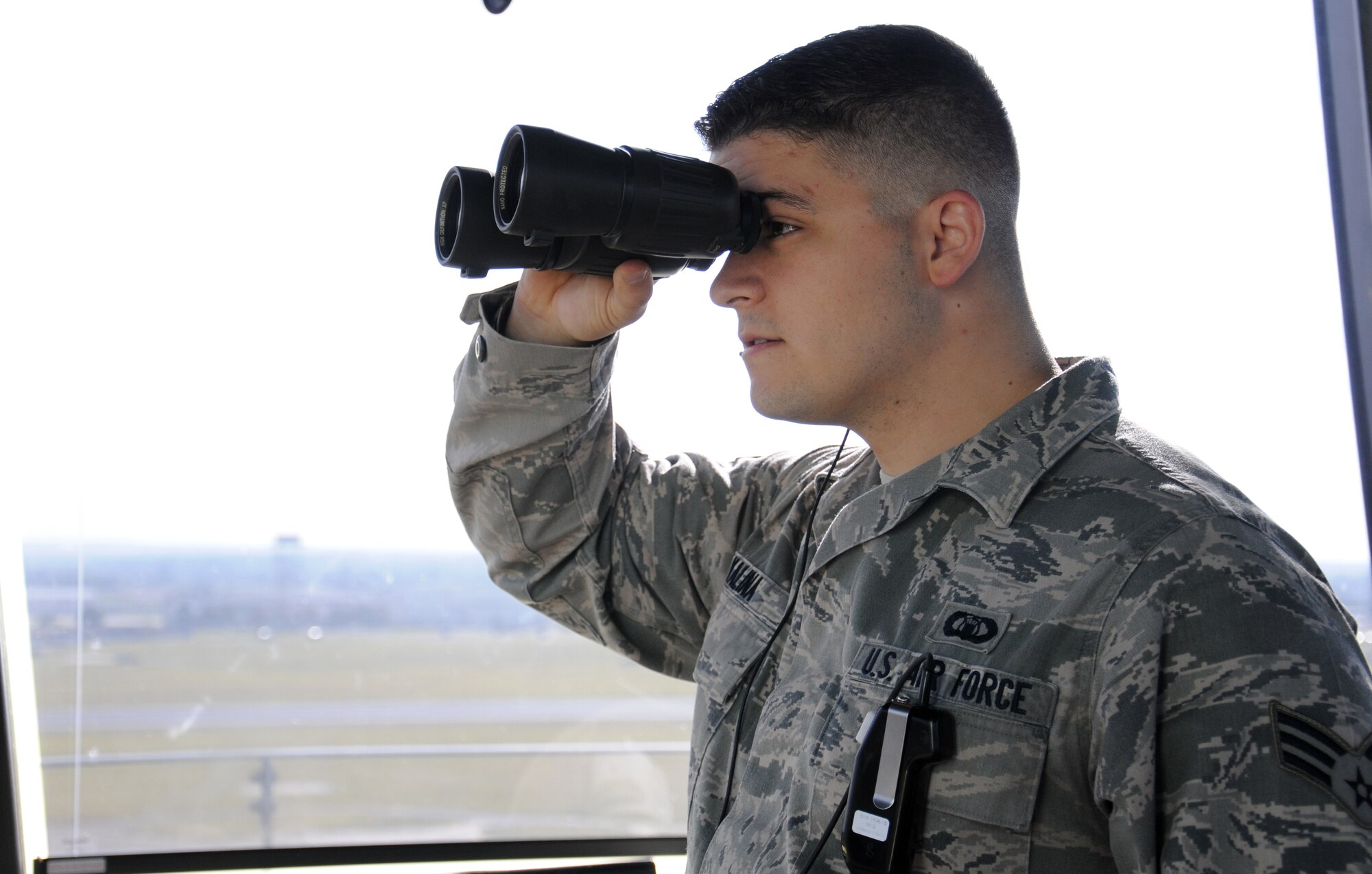 U.S. Air Force Senior Airman Andrew Kalina, 100th Operations Support Squadron Air Traffic Controller from Hoffman Estates, Ill., uses binoculars to ensure the safe landing of incoming aircraft Oct. 3, 2014, on RAF Mildenhall, England. The ATC career field is split into ATC and radar. In radar, Airmen coordinate with RAF Lakenheath which is a broad airspace of approximately 60 miles. (U.S. Air Force photo/Gina Randall/Released)