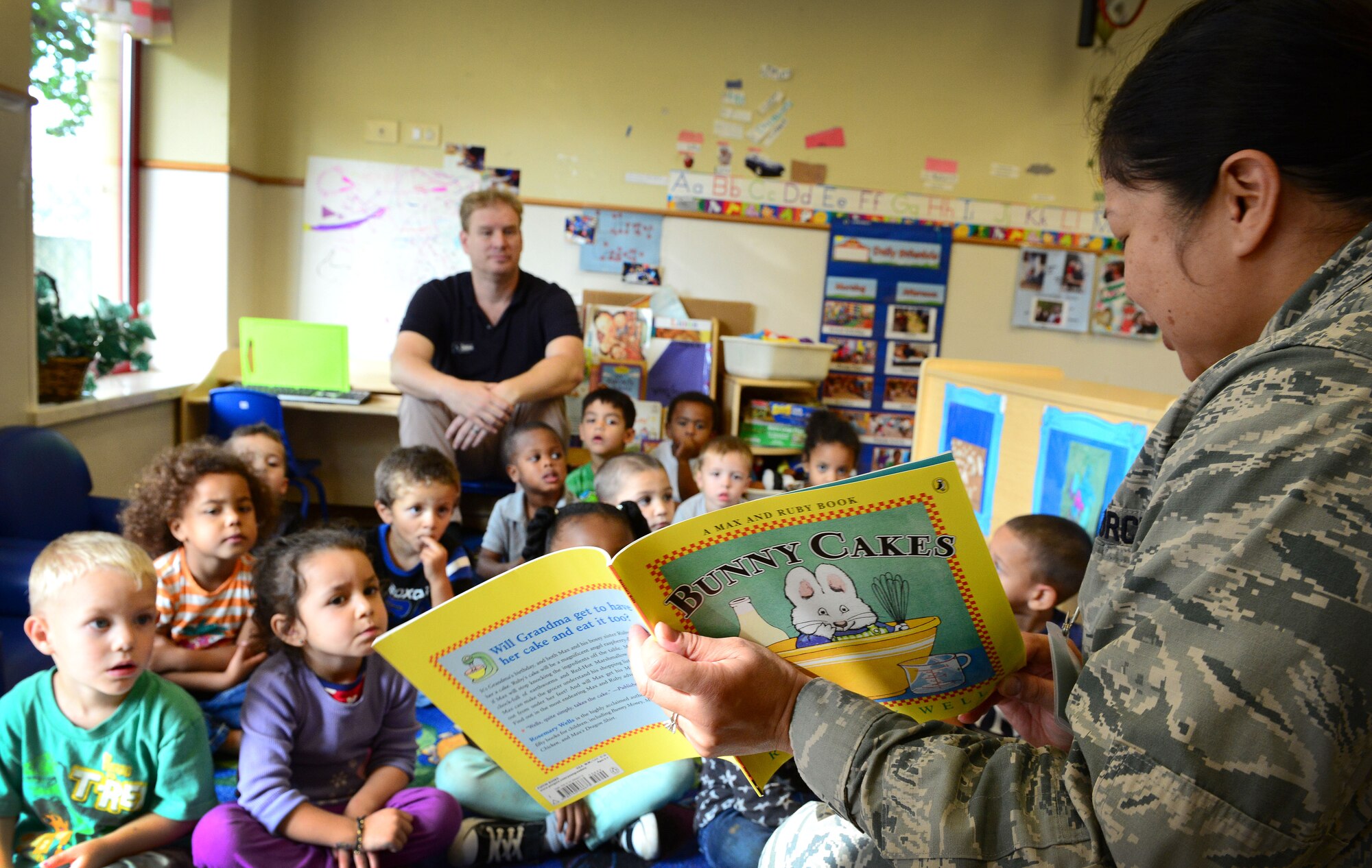 Lt. Col. Rosalie Duarte, 31st Force Support Squadron commander, reads to children at the Child Development Center during a “Read for the Record” pledge, Oct. 21, 2014, at Aviano Air Base, Italy. The pledge started Oct. 21 for people across America to read the children’s book, “Bunny Cakes,” in support of the Jumpstart mission: to work toward the day every child in America enters kindergarten prepared to succeed. (U.S. Air Force photo/Senior Airman Matthew Lotz)