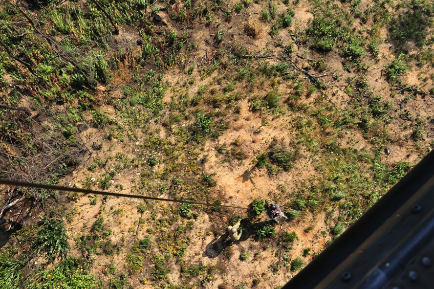 A survival, escape, resistance and evasion specialist helps a simulated survivor into the rescue strop during a combat search and rescue task force exercise, Oct. 15, 2014, Osan Air Base, Republic of Korea. The two-week exercise enables 33rd RQS aircrews to train for combat missions and prepares them for rescue missions in hostile territory. (U.S. Air Force photo by Staff Sgt. Rachelle Coleman/Released) 