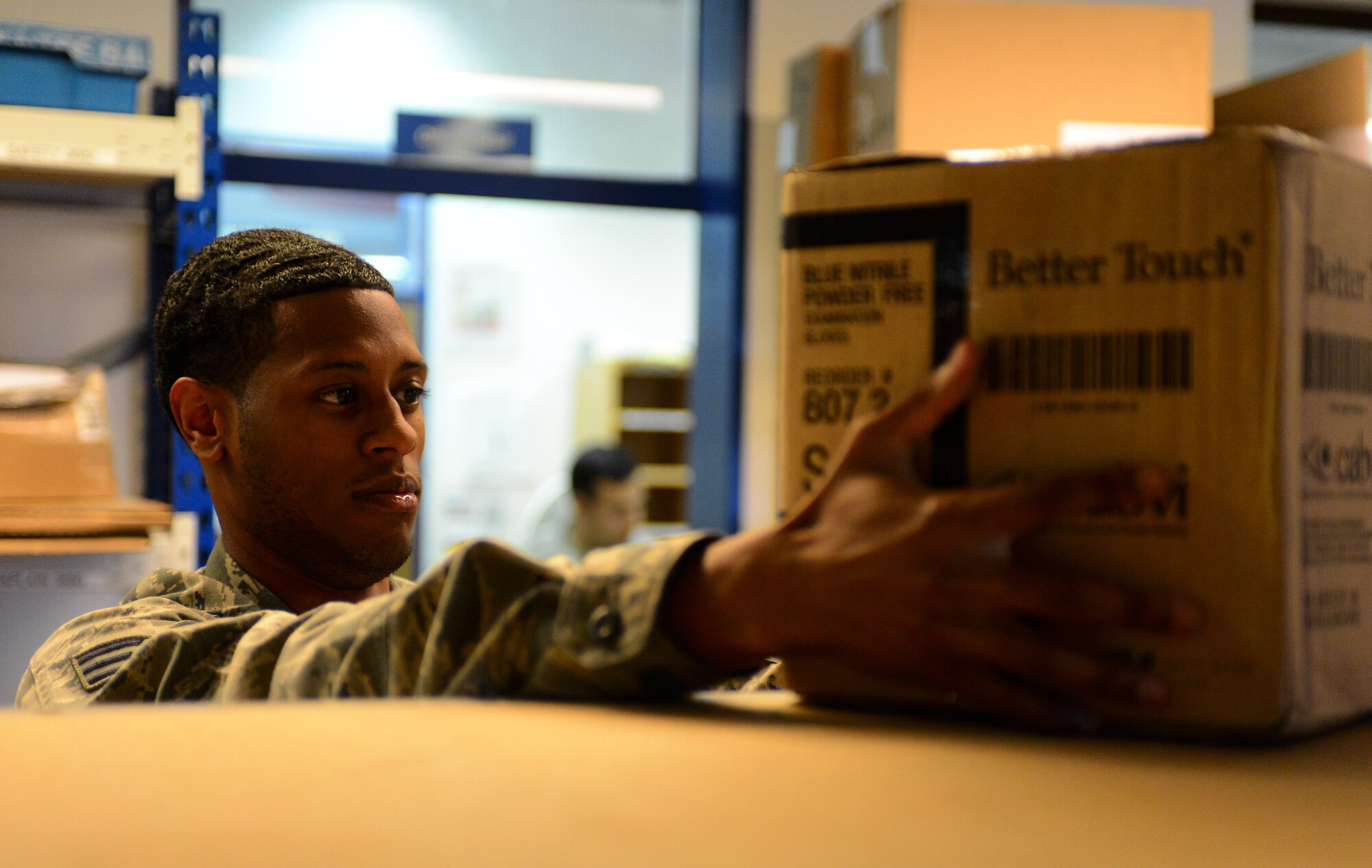 U.S. Air Force Senior Airman Kristofor Wallace, 52nd Communications postal clerk, and native of New York, places a package on a shelf while organizing mail at the post office on Spangdahlem Air Base, Germany, Oct. 21, 2014. The post office has created deadlines for mailing to the U.S. in order for mail to arrive in the states on time for the holidays. (U.S. Air Force photo by Airman 1st Class Luke J. Kitterman/Released)

