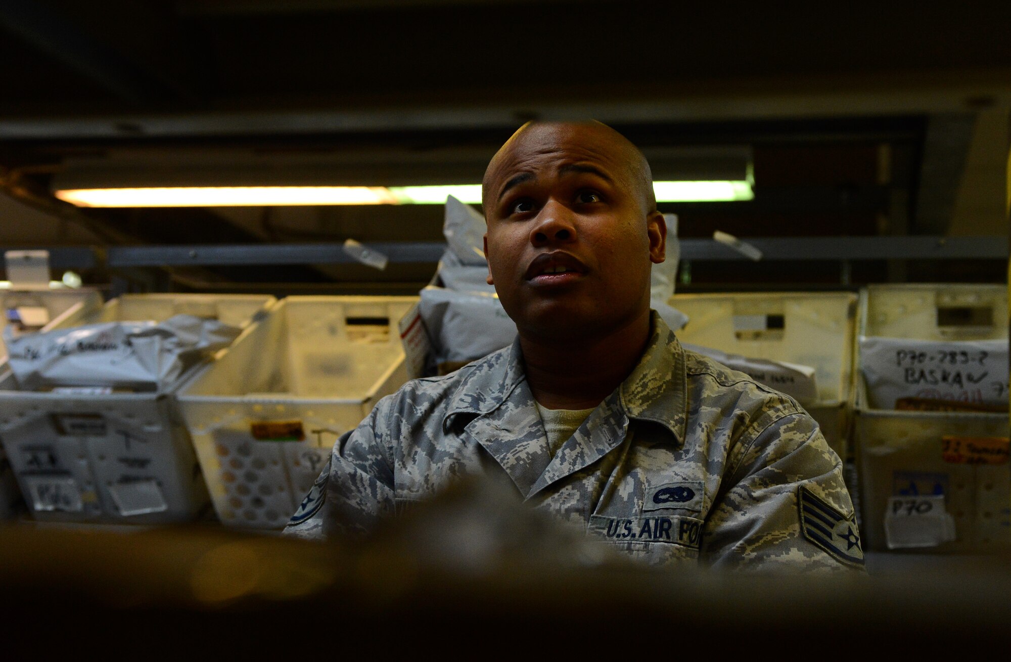 U.S. Air Force Staff Sgt. Troy Whetstone, 52nd Communications Squadron postal service center NCO in charge, and native of Tumwater, Wash., processes incoming mail at the post office on Spangdahlem Air Base, Germany, Oct. 21, 2014. With the holidays right around the corner, the post office will be in need of volunteers to help with the influx of mail. (U.S. Air Force photo by Airman 1st Class Luke J. Kitterman/Released)