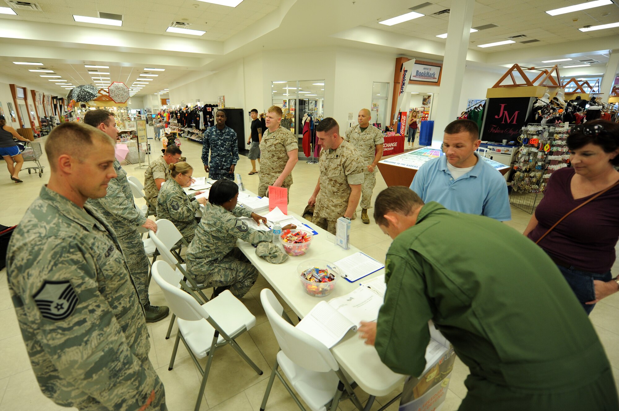 U.S. Air Force Capt Robert Espy, Kadena voting officer, and Marine Warrant Officer John Squares, Marine Core Base assistant voting officer, host a joint information booth on Oct. 21,2014, inside the Kadena Exchange, Okinawa, Japan. They hosted this event in an effort to push the importance of registering to vote. (U.S. Air Force photo by Airman 1st Class Stephen G. Eigel/Released)
