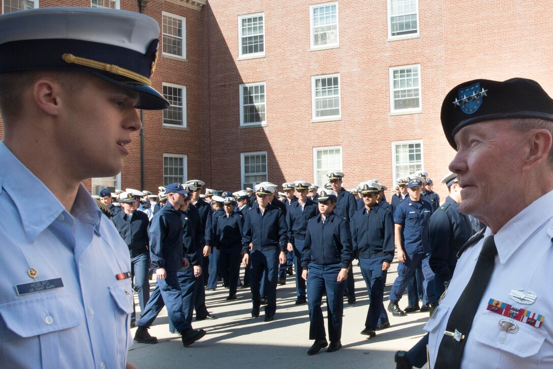 Army Gen. Martin E. Dempsey, right, chairman of the Joint Chiefs of Staff, speaks to a Coast Guard cadet at the U.S. Coast Guard Academy in New London, Conn., Oct. 21, 2014. Dempsey visited the academy to speak with future Coast Guard officers and faculty about topics ranging from future missions to leadership.  