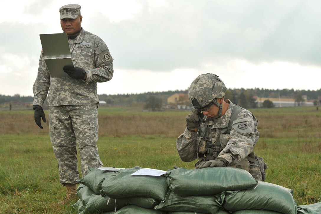 U.S. Army Pvt. Felipe Marquez, right, calls in a fire mission during the Expert Infantryman Badge qualification on the Joint Multinational Training Command’s Grafenwoehr Training Area, Germany, Oct. 21, 2014. 