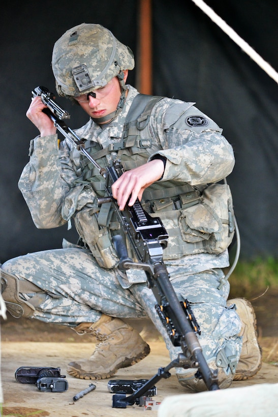 U. S. Army Spc. Eathen Mitchell assembles an M249 light machine gun during the 2nd Cavalry Regiment  Expert Infantryman Badge qualification on the Joint Multinational Training Command’s Grafenwoehr Training Area, Germany, Oct. 21, 2014. 
