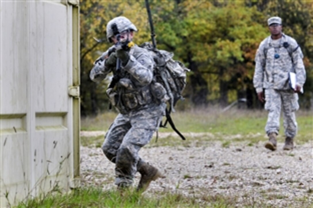 U.S. Army Staff Sgt. Christopher Shaul, left, fires blank rounds during Expert Infantryman Badge qualification on the Joint Multinational Training Command’s Grafenwoehr Training Area, Germany, Oct. 20, 2014. Shaul is assigned to the 2nd Cavalry Regiment.