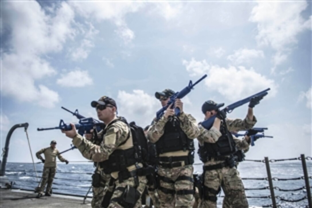 U.S. members of the visit, board, search and seizure team on the guided-missile destroyer USS Halsey conduct an evacuation drill during a training exercise in the South China Sea, Oct. 17, 2014. The Halsey is deployed to the U.S. 7th Fleet area of responsibility supporting security and stability in the Indo-Asia-Pacific region. 