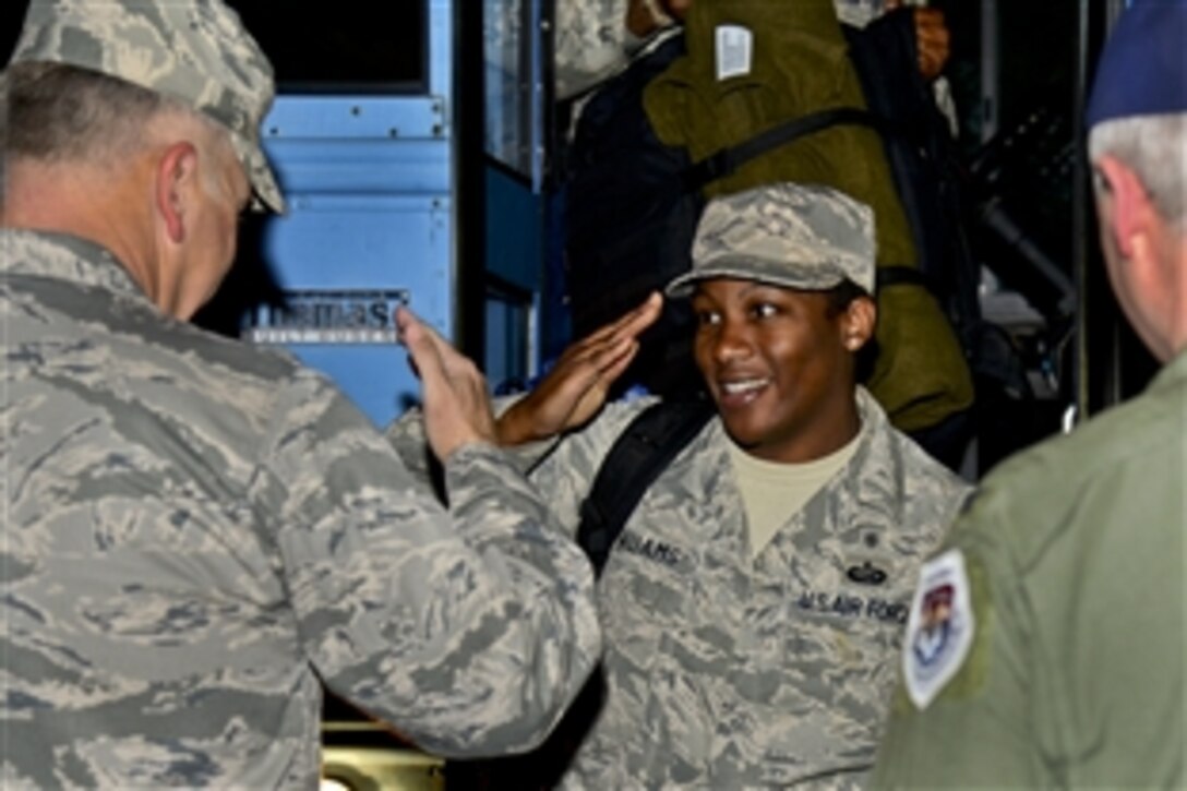 Air Force Staff Sgt. Fanta Williams, right, salutes Air Force Col. John J. Allen Jr., commander of the 633rd Air Base Wing, during a homecoming ceremony on Langley Air Force Base, Va., Oct. 20, 2014. Airmen assigned to the 633rd Medical Group deployed to West Africa to support Operation United Assistance, where they delivered and built an Air Force medical support system. Williams is a medic assigned to the 633rd Medical Operations Squadron.  