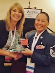 Lori A. Paschall, CDA, CPFDA, FADAA, American Dental Assistant Association (ADAA) president, Presents the ADAA President's Award to Master Sgt. Lisa Lund, METC Air Force Dental Assistant program course supervisor, during the ADAA Annual Session at the Westin Riverwalk Hotel October 11, 2014. (Photo by Santos Robles, ADAA)
