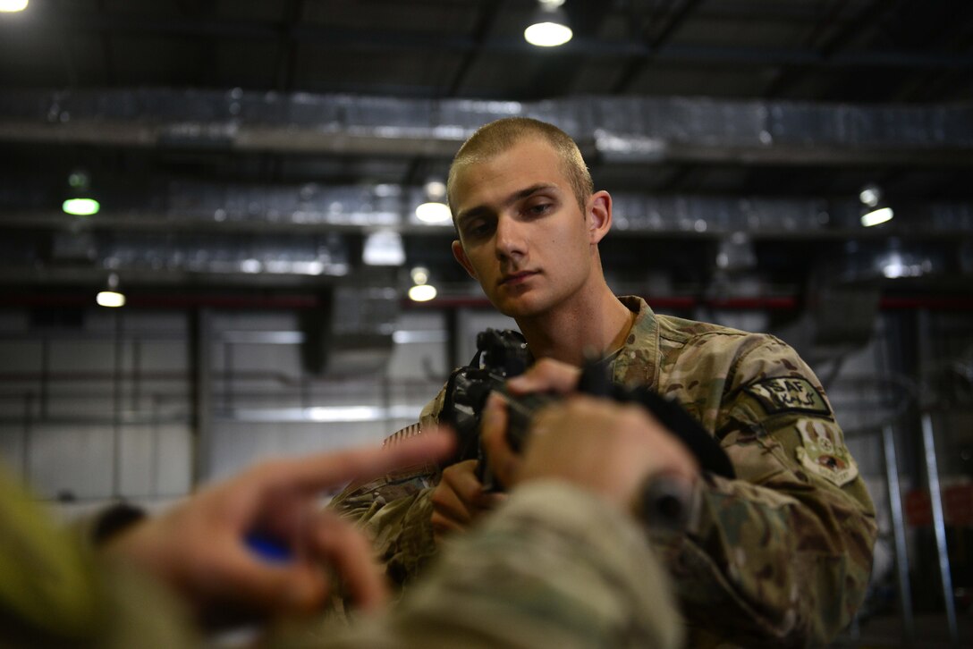 U.S. Air Force Airman 1st Class Jon Peterson, 455th Expeditionary Aerial Port Squadron aerial porter, receives Check Six program instruction at Bagram Airfield, Afghanistan Oct. 21, 2014.  The program is designed to increase military members’ awareness and practice muscle memory that will become critical in the event of an attack or violent occurrence.  Peterson is deployed from Travis Air Force Base, Calif. and a native of Fairbanks, Alaska. (U.S. Air Force photo by Staff Sgt. Evelyn Chavez/Released)