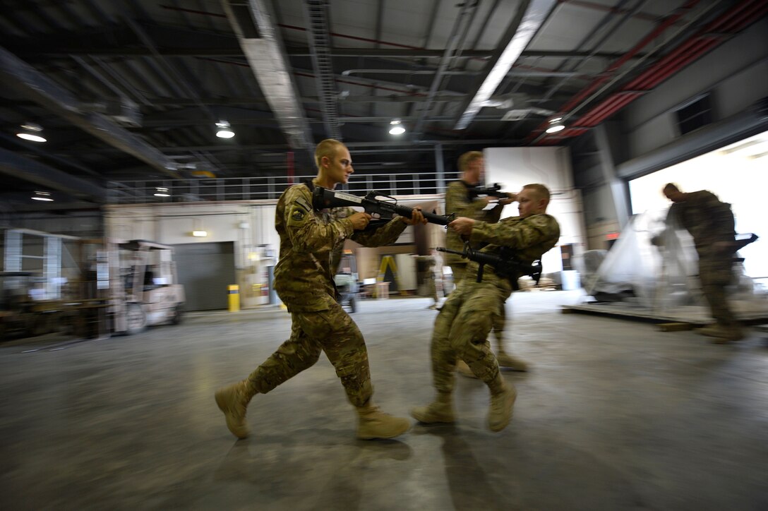 (From left) U.S. Air Force Airman 1st Class Jon Peterson, 455th Expeditionary Aerial Port Squadron aerial porter, and Senior Airman Cameron Corricelli, 455 EAPS aerial porter, participate in Check Six program instruction at Bagram Airfield, Afghanistan Oct. 21, 2014.  The program is designed to increase military members’ awareness and practice muscle memory that will become critical in the event of an attack or violent occurrence.  Peterson is deployed from Travis Air Force Base, Calif. and a native of Fairbanks, Alaska. Corricelli is deployed from Charleston Air Force Base, South Carolina and a native of Nashua New Hampshire.  (U.S. Air Force photo by Staff Sgt. Evelyn Chavez/Released)