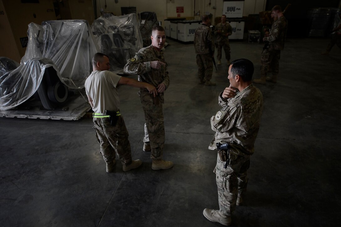 U.S. Air Force Airmen with the 455th Expeditionary Aerial Port Squadron listen to Check Six program training instructions at Bagram Airfield, Afghanistan Oct. 21, 2014. Airmen recently participated in the training, which is intended to help increase Airmen’s awareness and vigilance in case of an active shooter event. (U.S. Air Force photo by Staff Sgt. Evelyn Chavez/Released)