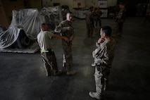 U.S. Air Force Airmen with the 455th Expeditionary Aerial Port Squadron listen to Check Six program training instructions at Bagram Airfield, Afghanistan Oct. 21, 2014. Airmen recently participated in the training, which is intended to help increase Airmen’s awareness and vigilance in case of an active shooter event. (U.S. Air Force photo by Staff Sgt. Evelyn Chavez/Released)