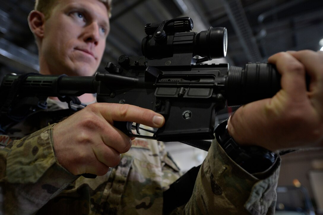U.S. Air Force Staff Sgt. Joshua Bowers, 455th Expeditionary Aerial Port Squadron aerial porter, practices weapon drills during Check Six program training at Bagram Airfield, Afghanistan Oct. 21, 2014. The program is designed to increase military members’ awareness and practice muscle memory that will become critical in the event of an attack or violent occurrence.  Bowers is deployed from Charleston Air Force Base, South Carolina and a native of Alvin, Texas.  (U.S. Air Force Photo by Staff Sgt. Evelyn Chavez/Released)
