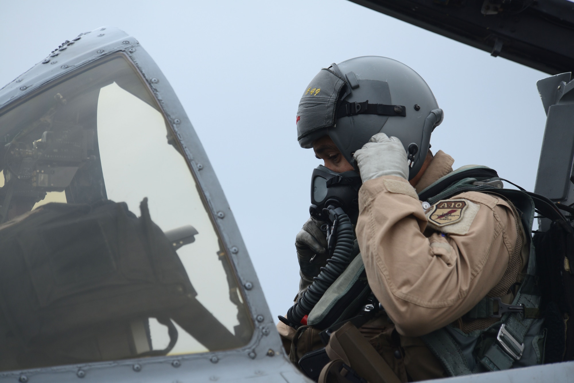BAGRAM AIRFIELD, Afghanistan -  U.S. Air Force Lt. Col Bryan Stone, 303rd Expeditionary Fighter Squadron commander, ensures his breathing apparatus operates correctly in an A-10 Thunderbolt II prior to takeoff Oct. 19, 2014 at Bagram Airfield, Afghanistan. The 303 EFS was responsible for close air support operations throughout Afghanistan and was succeeded by the 163rd Expeditionary Fighter Squadron. The 303 EFS will return to the 442nd Fighter Wing at Whiteman Air Force Base, Mo. (U.S. Air Force photo by Master Sgt. Cohen A. Young/Released)